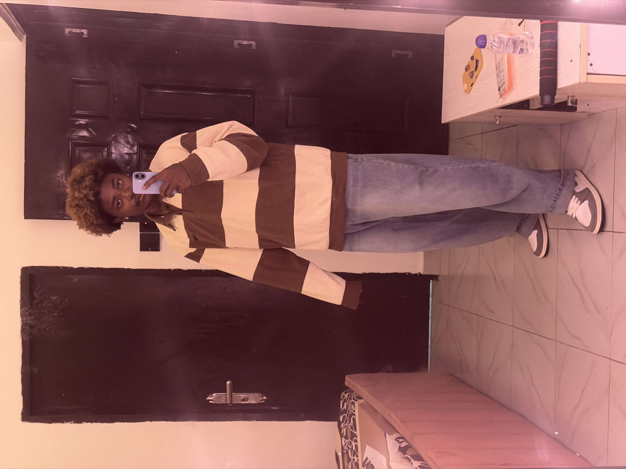 Man takes mirror selfie in Igboefon, Nigeria