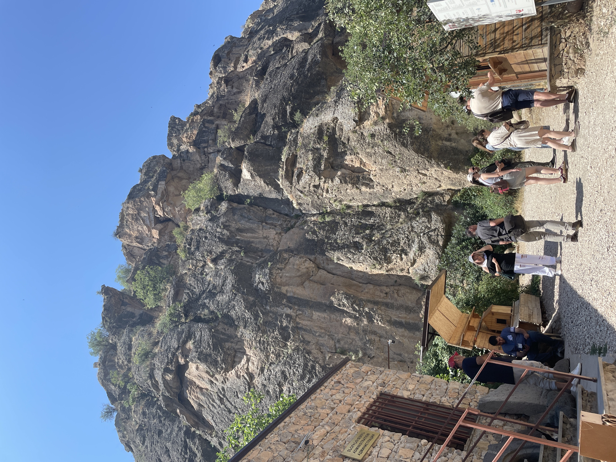 Tourists pause at Areni's cliff-base administration building