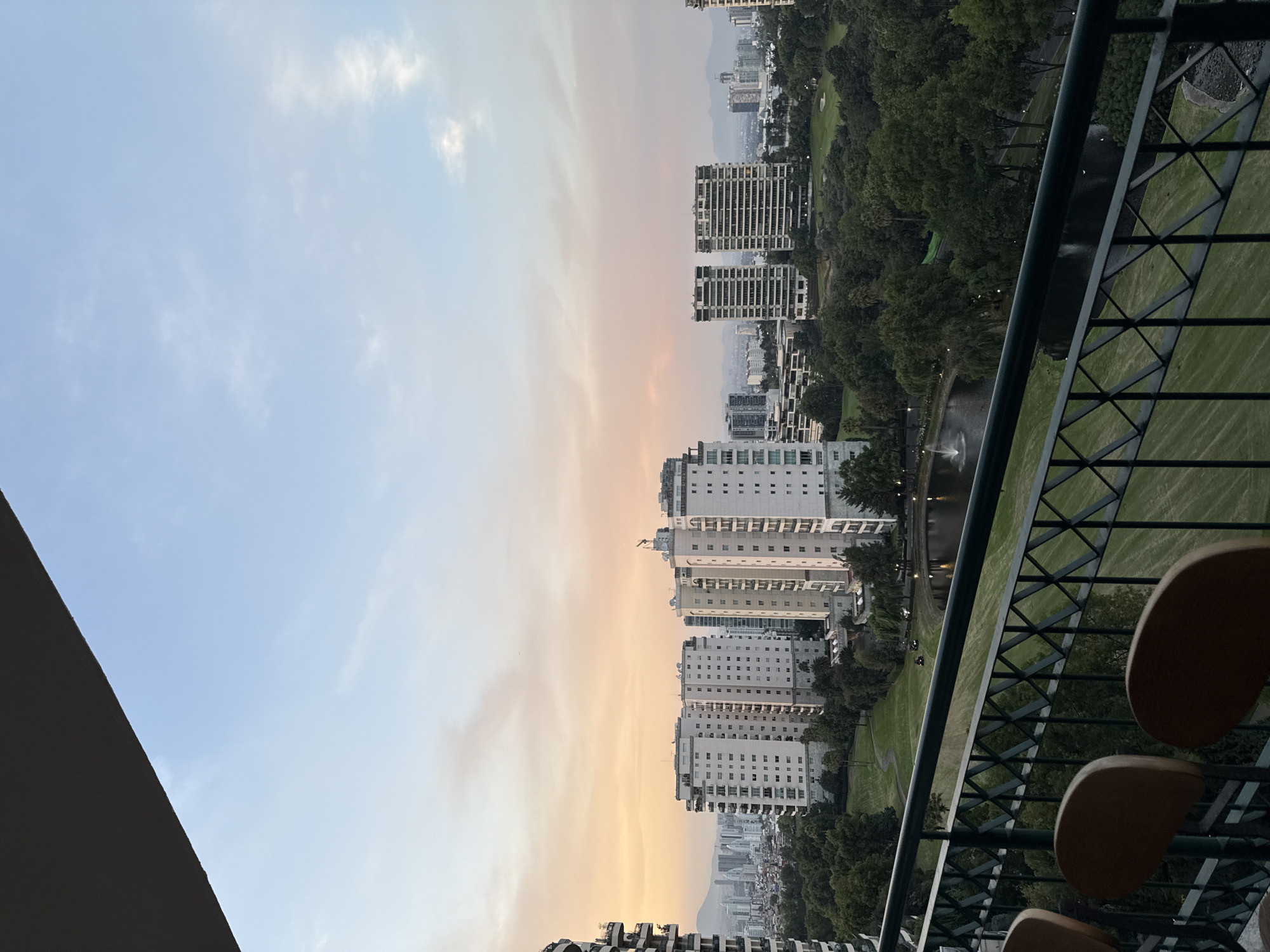 Golden hour cityscape view captured from Mexico City balcony