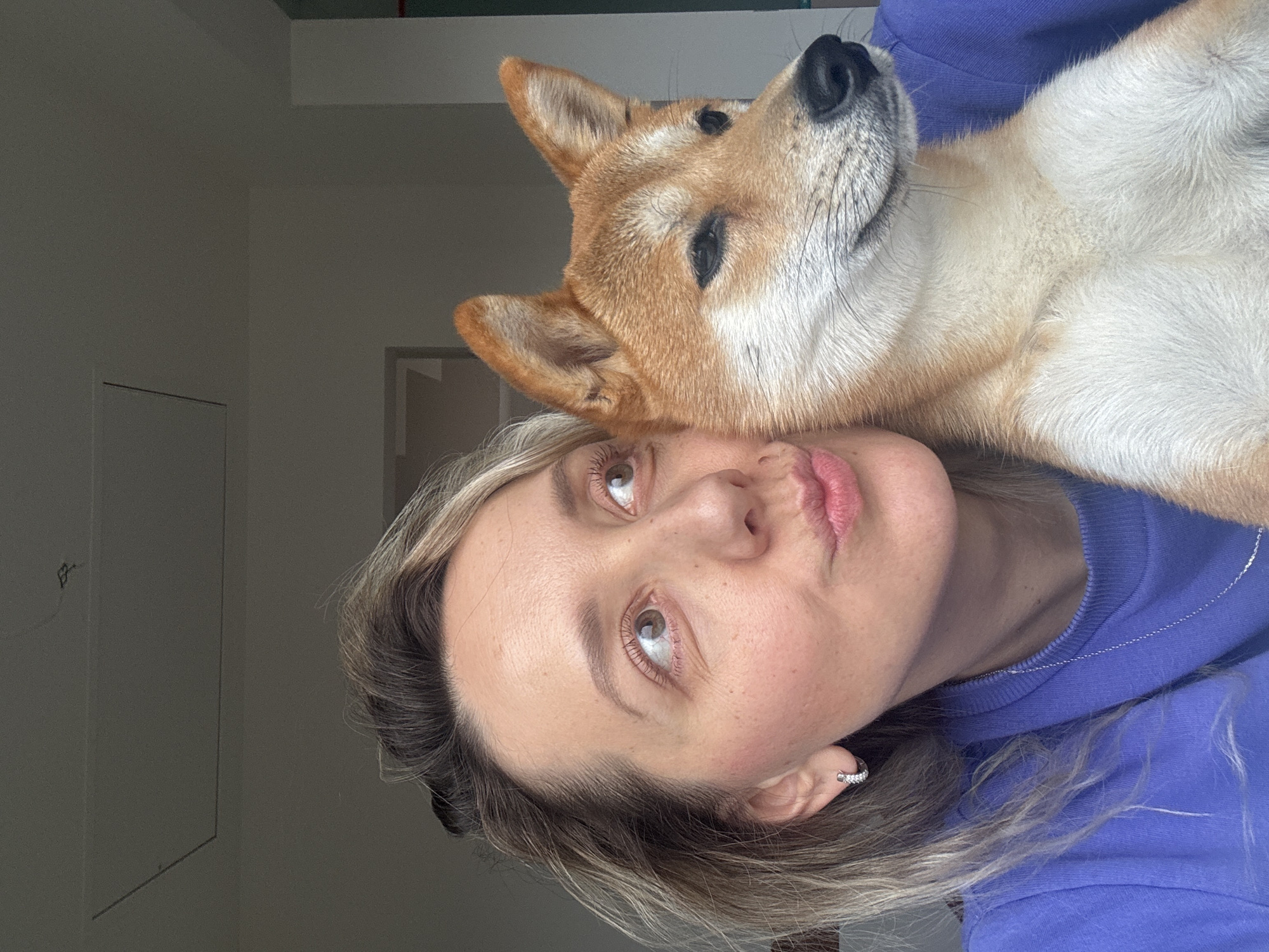 Woman and Shiba Inu captured in playful moments in Latvia