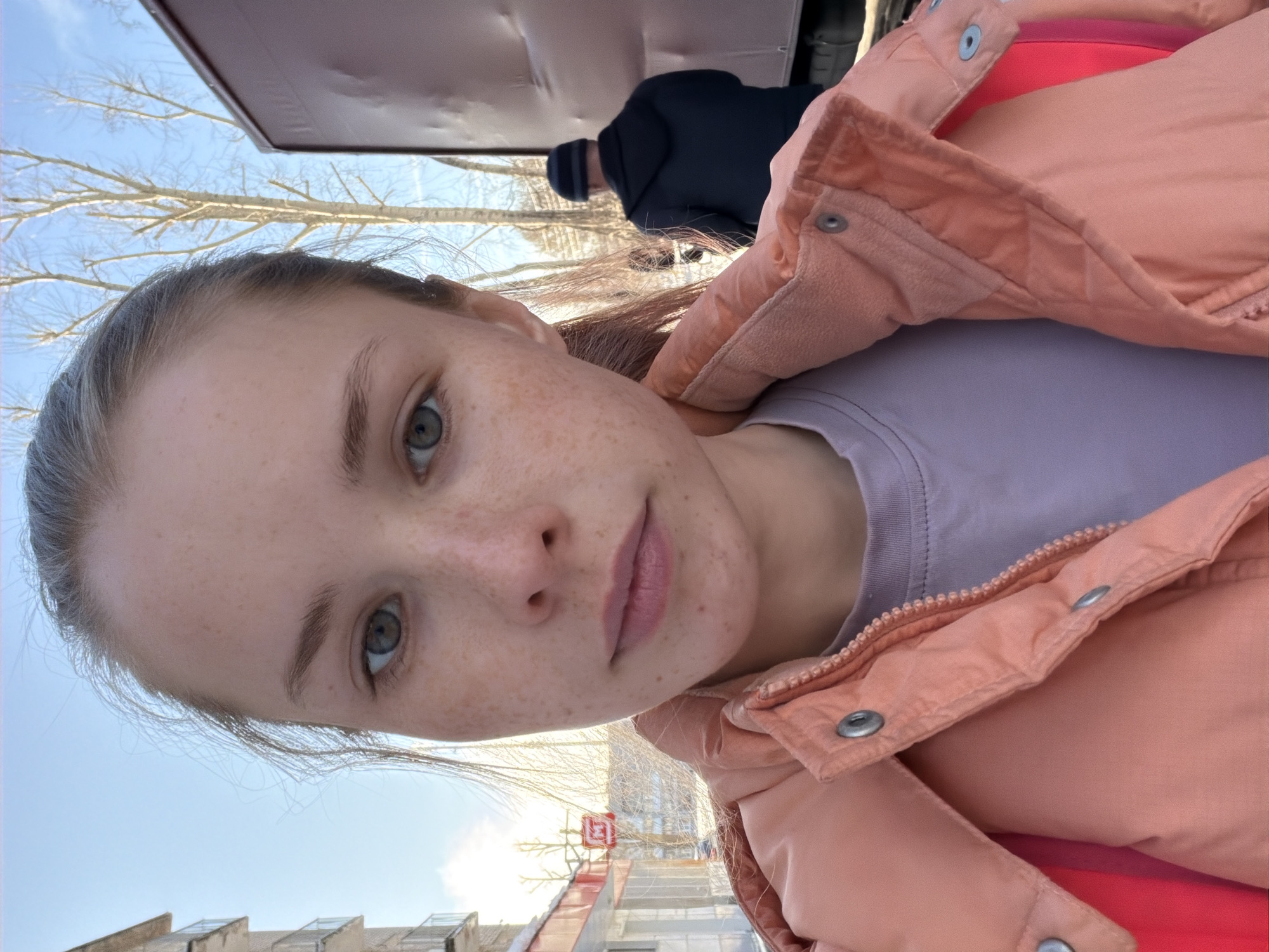 Young woman documents sunny spring day in Berezniki, Russia