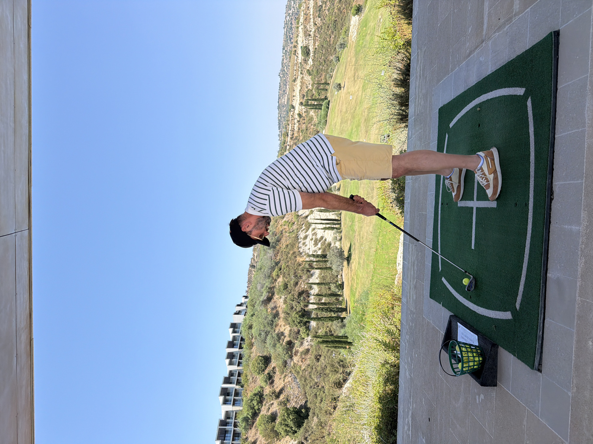 Swinging at the driving range in Tsada, Cyprus
