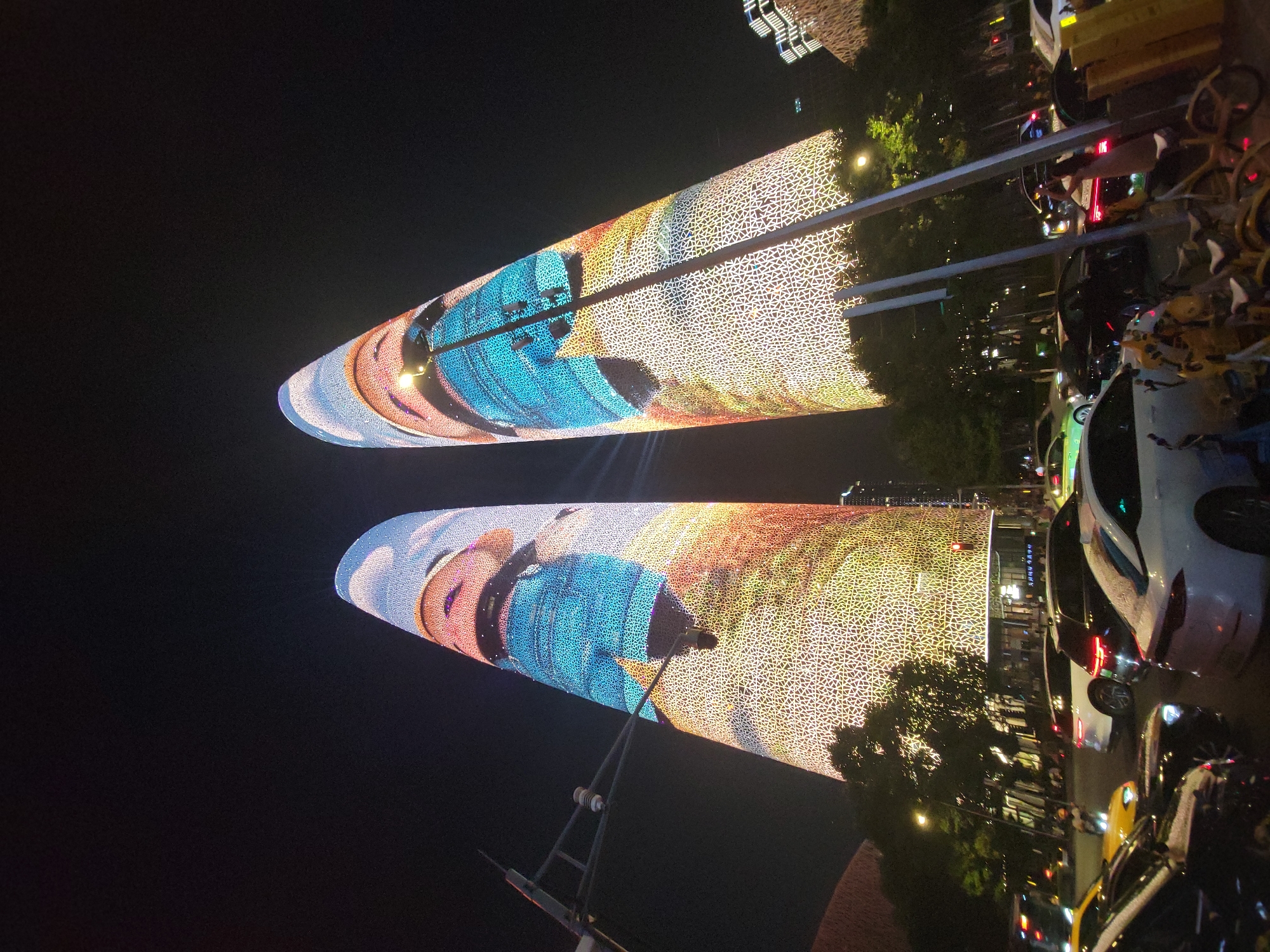 Chengdu's twin towers cycling through vivid LED facade displays at night