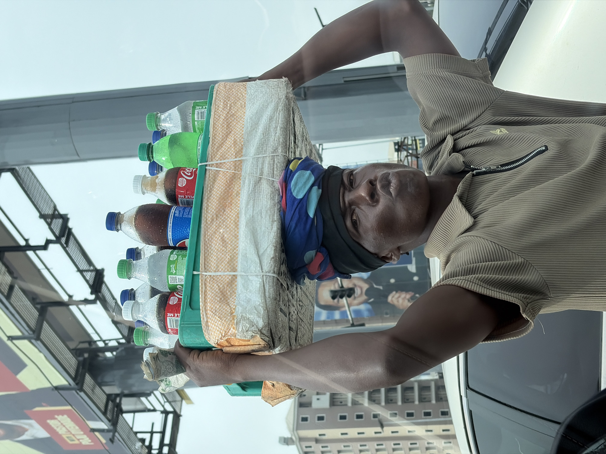 Street vendors sell drinks and fruit in Alaguntan, Nigeria