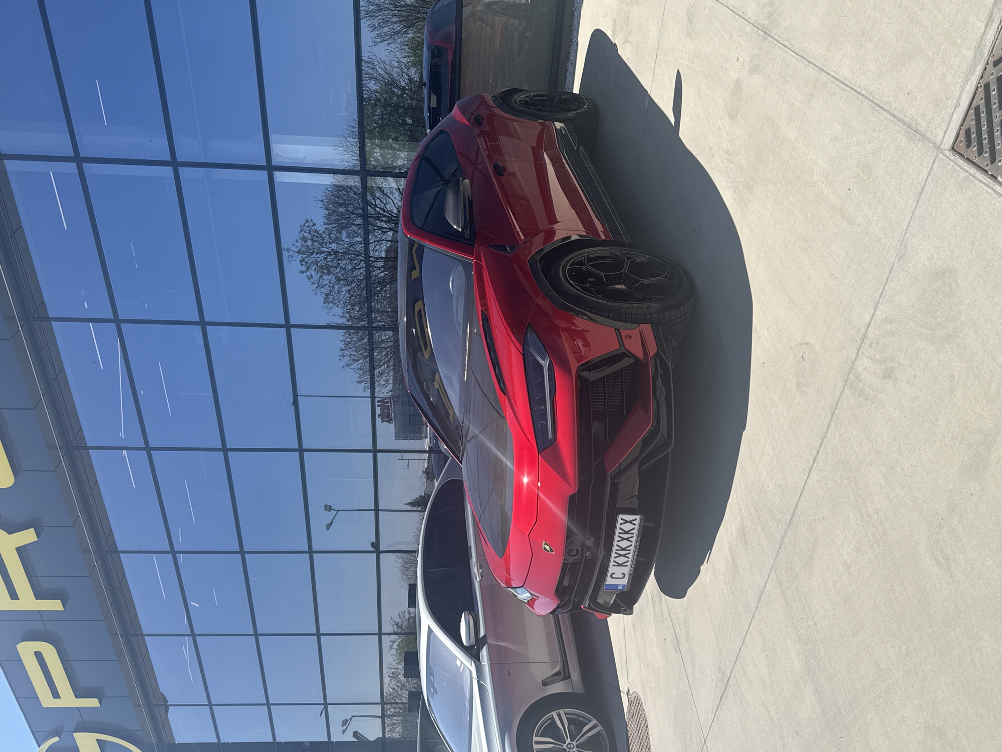 Red Lamborghini Urus spotted parked outside modern building in Plovdiv