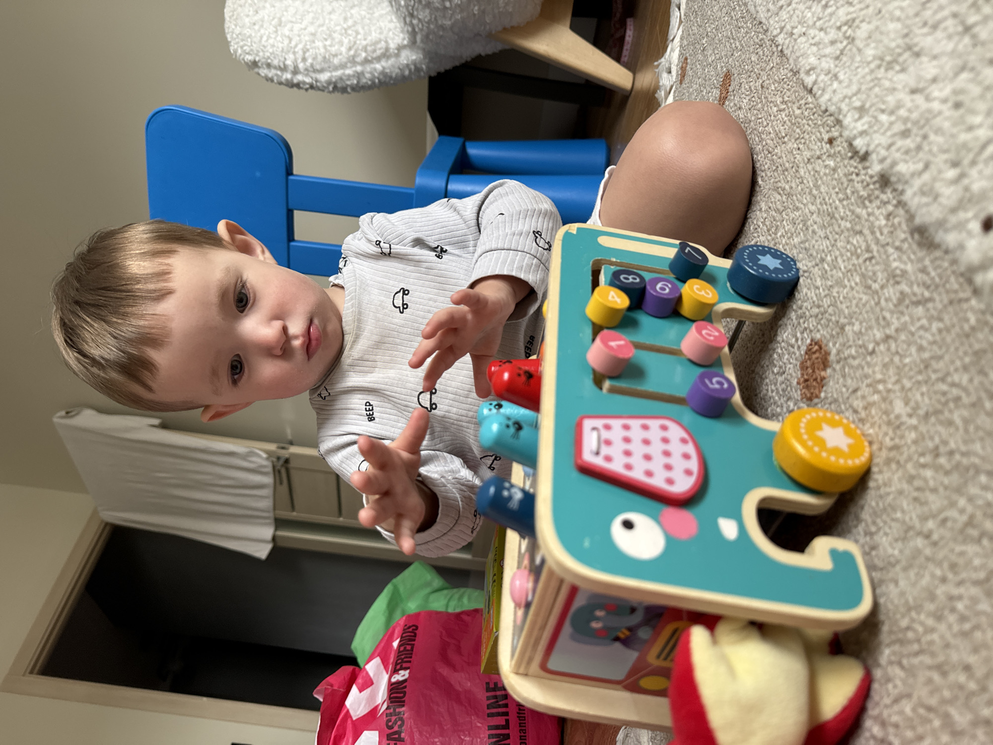 Toddler plays with wooden toys in Odintsovo home