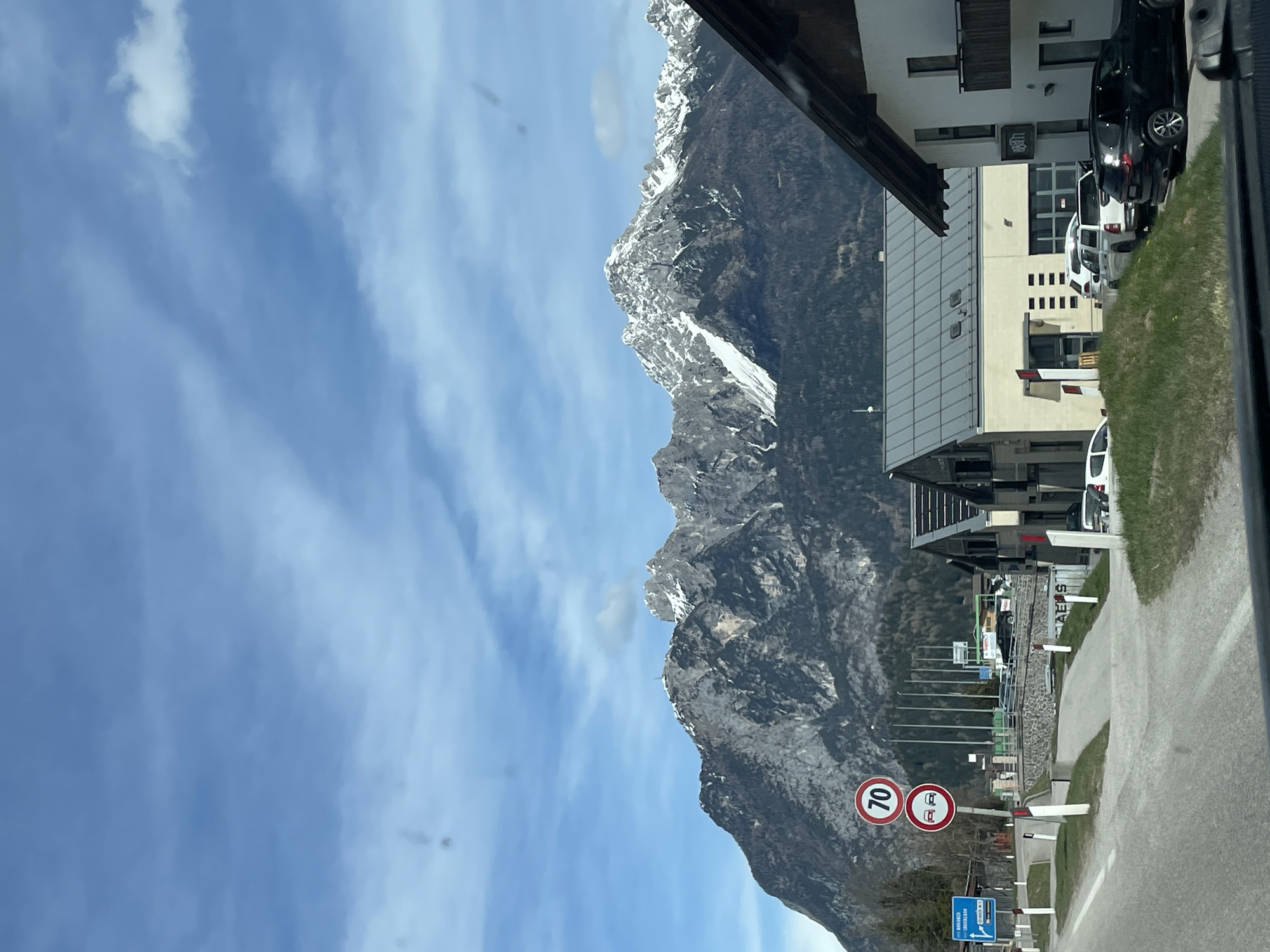 Vehicle travels scenic mountain route through Cadore region, Italy