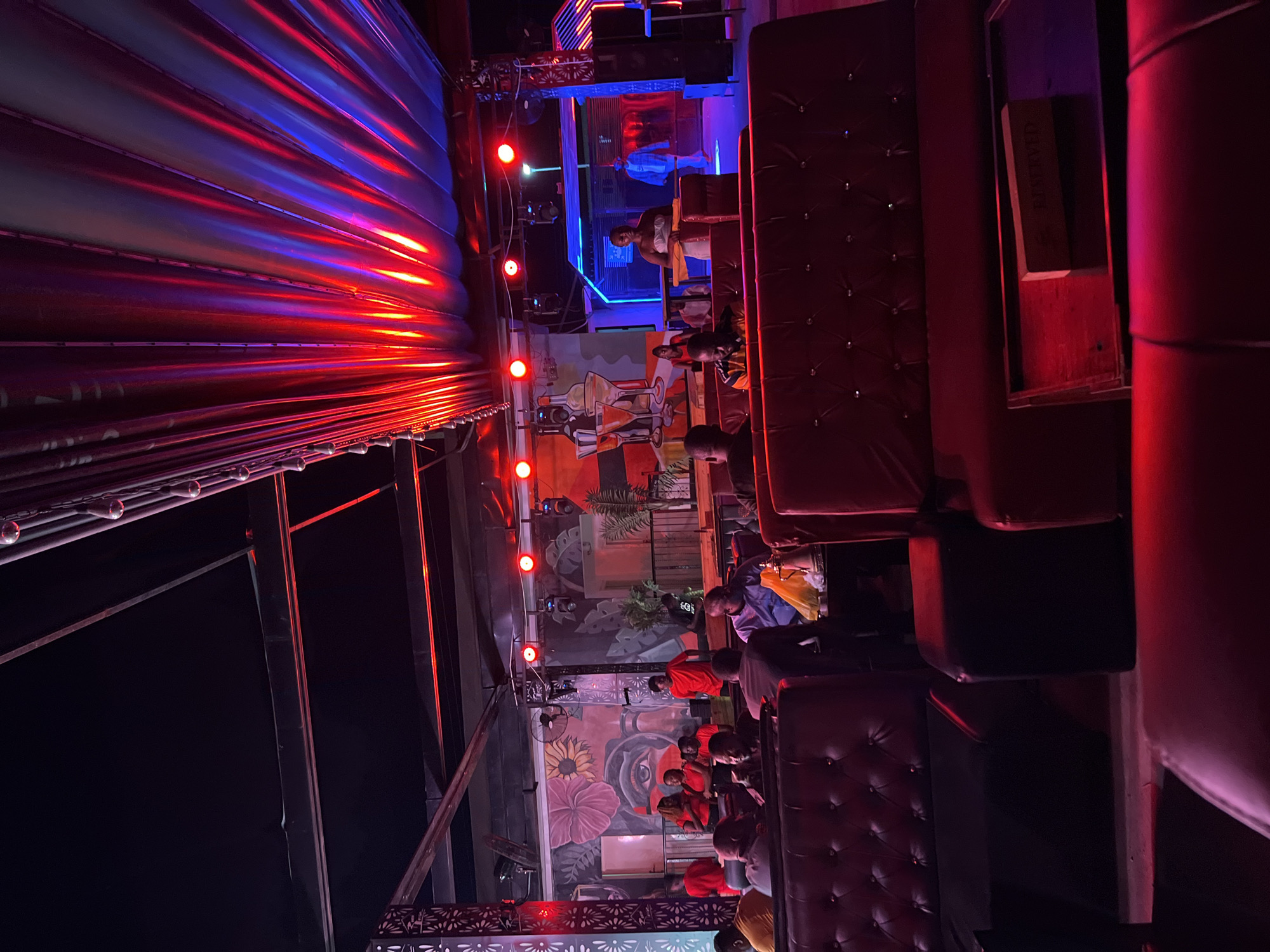Night venue in Howayi lit up with DJ setup and lounge areas