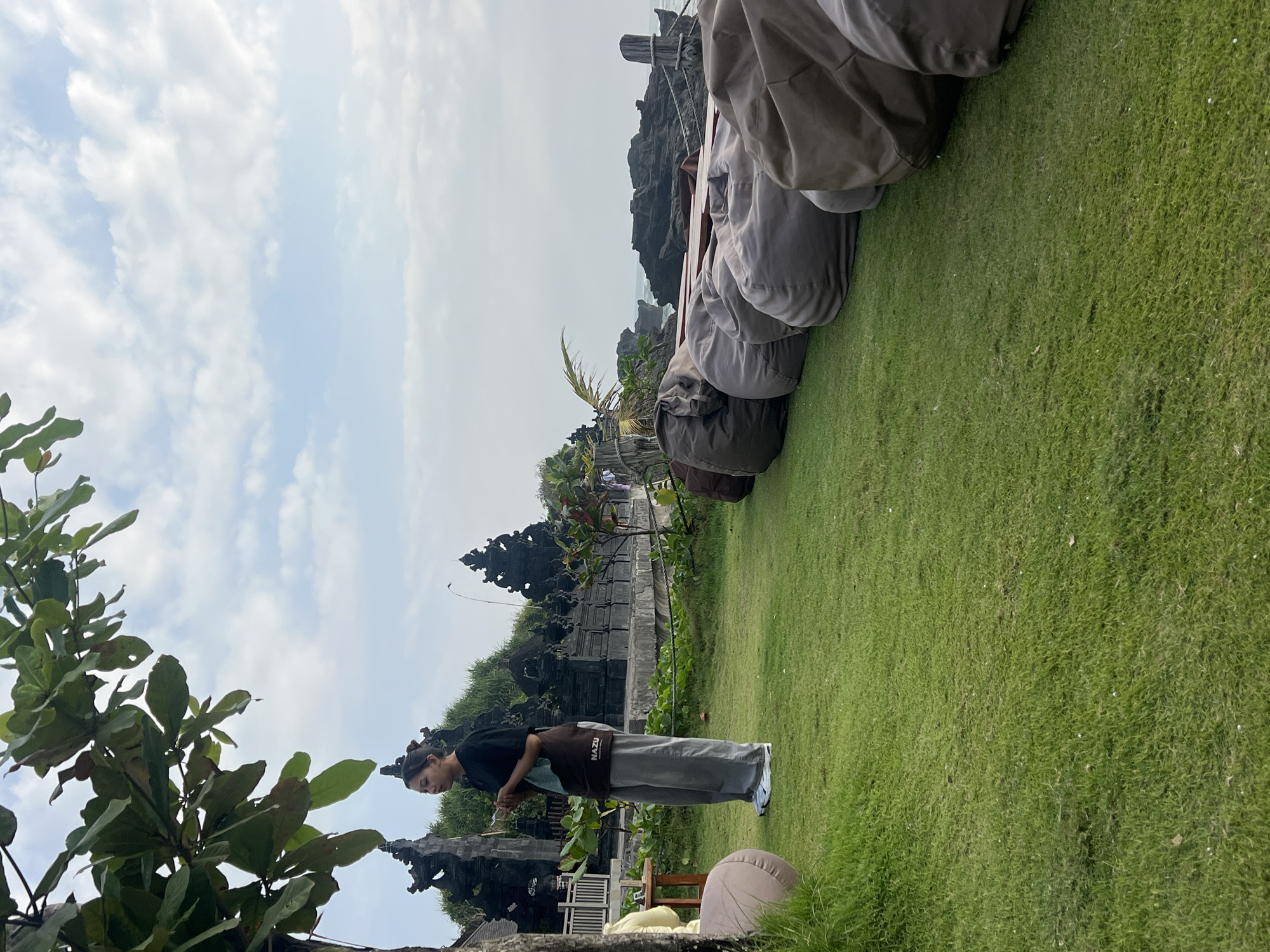 Lazy morning at Taman Ayun — temples, rocky beach, and a white dog