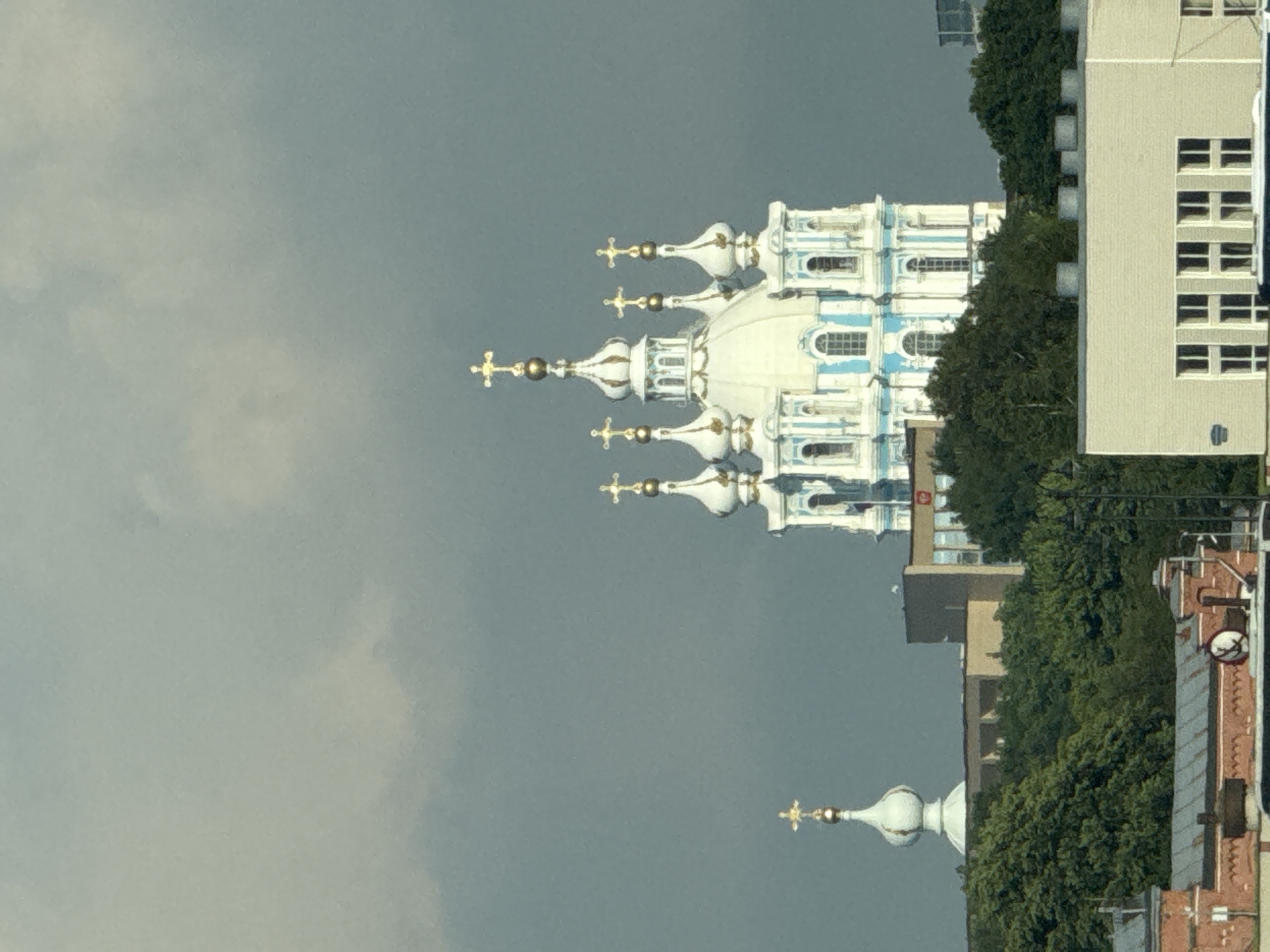 Historic domed church rises under cloudy Saint Petersburg skies