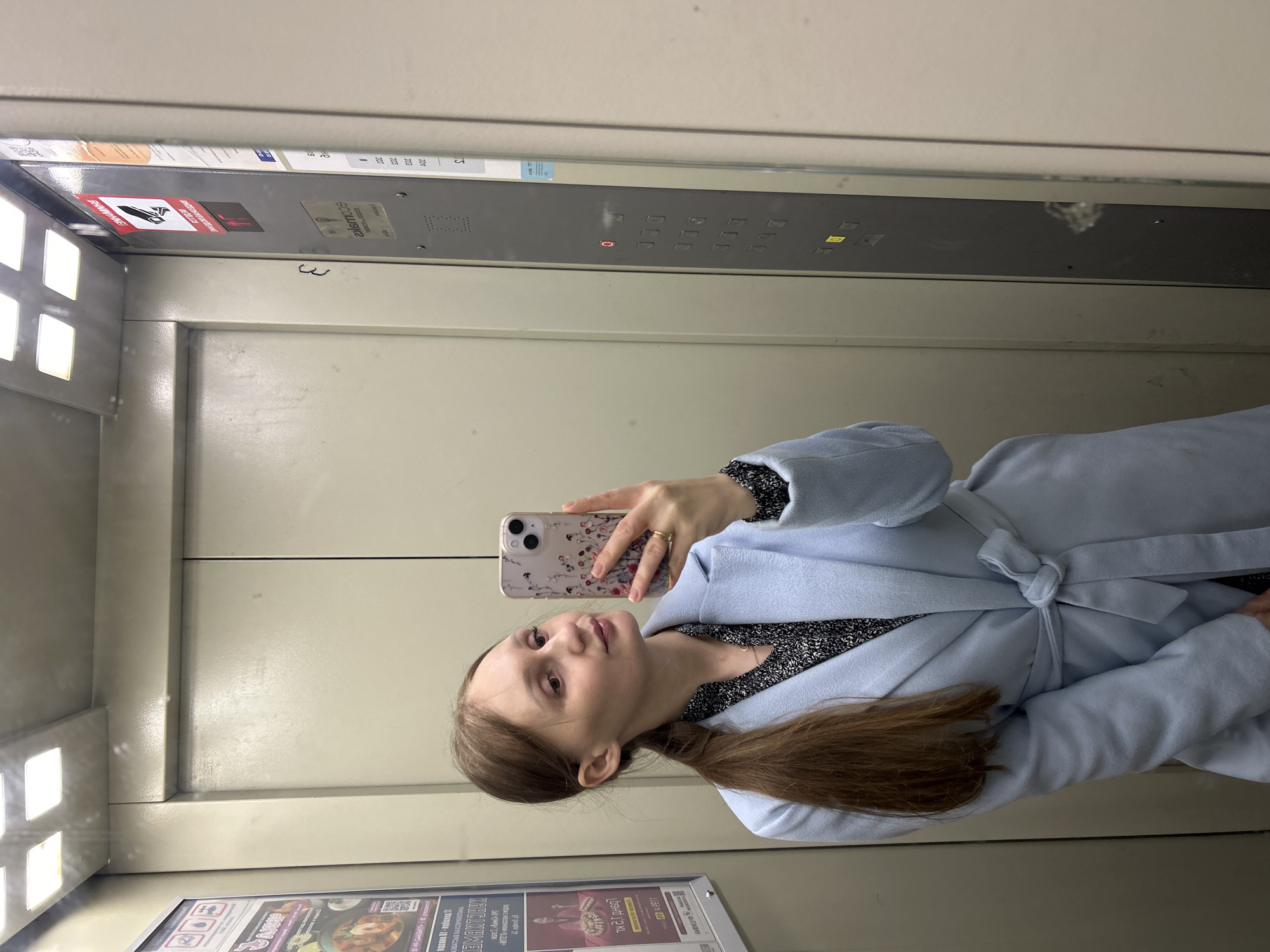Woman takes selfie in Ufa elevator