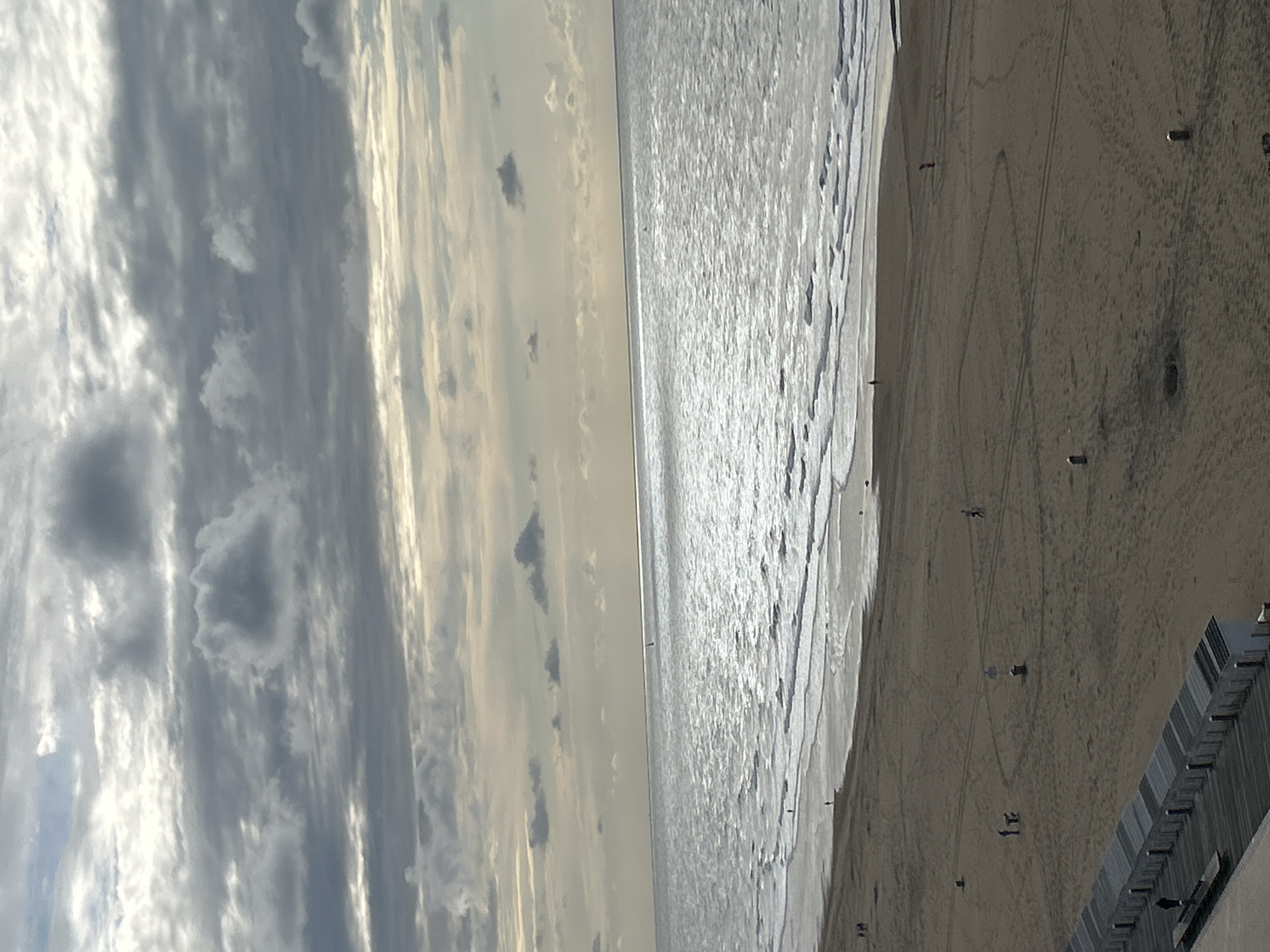 Ostend beach: cargo ships, clouds, and a crowd on the sand