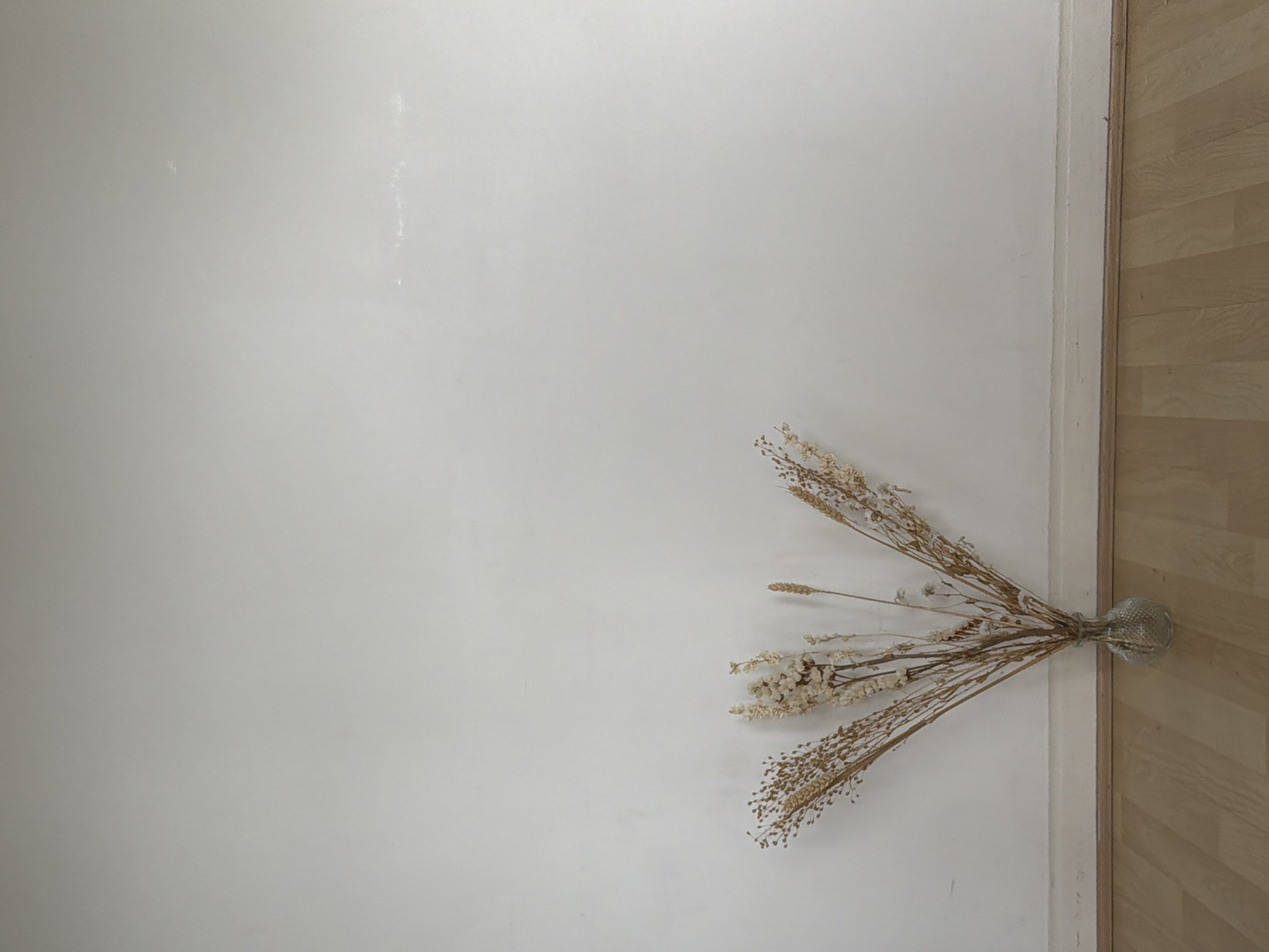 Dried wheat arrangement documented in London home setting