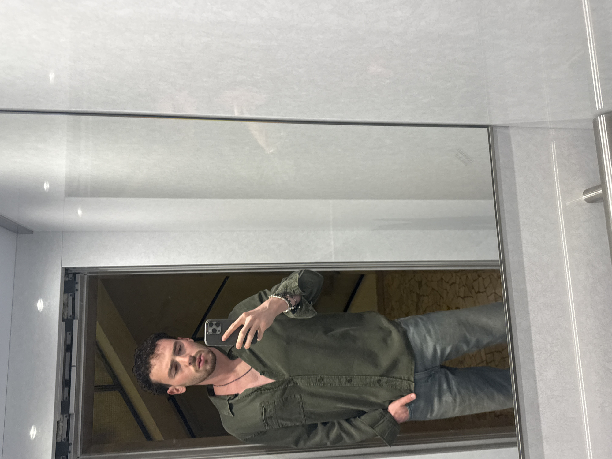 Man Takes Selfie in Mirrored Elevator in Milan