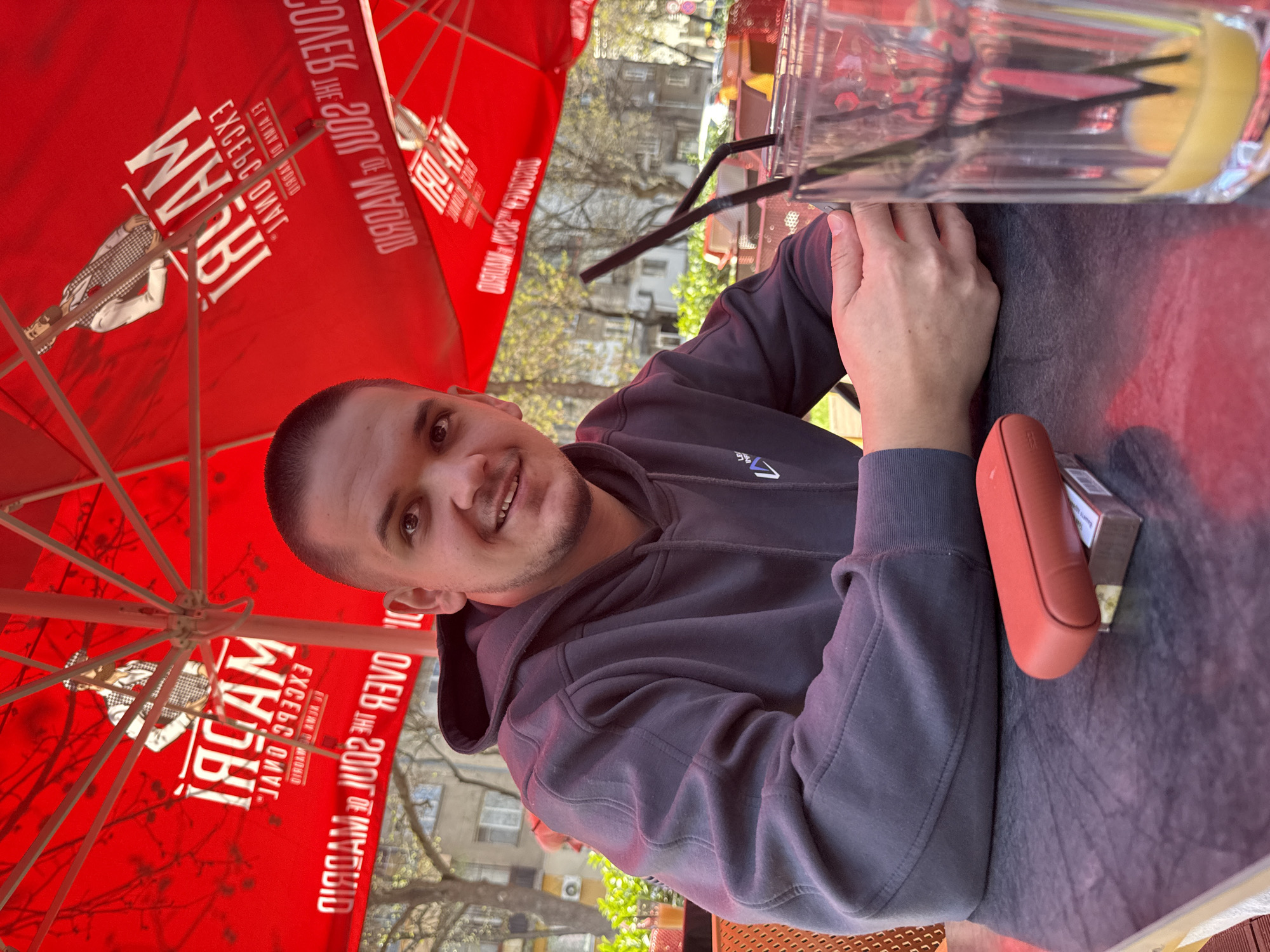 Man uses phone at outdoor cafe in Plovdiv