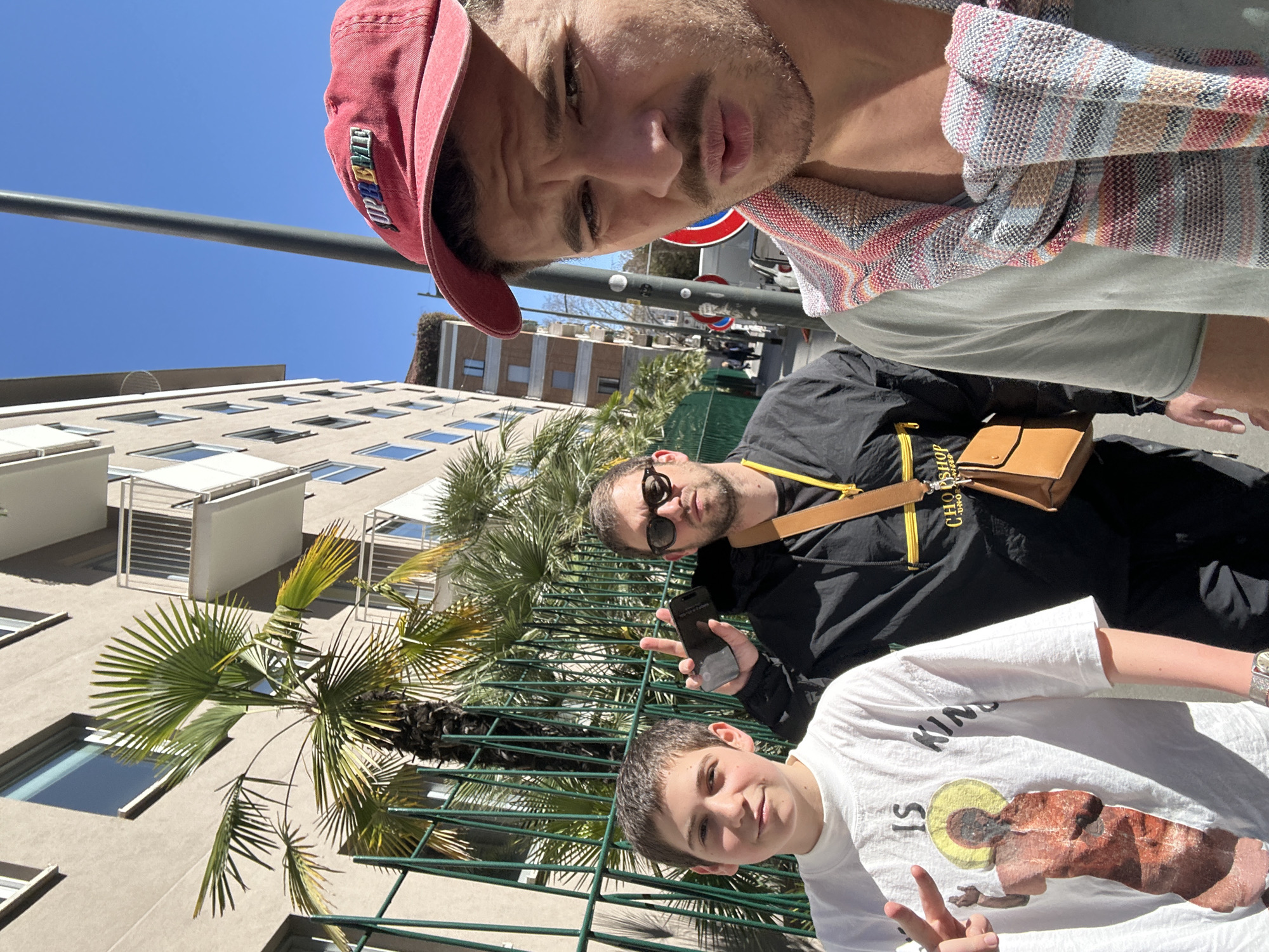 Three people pose for selfie on Milan street
