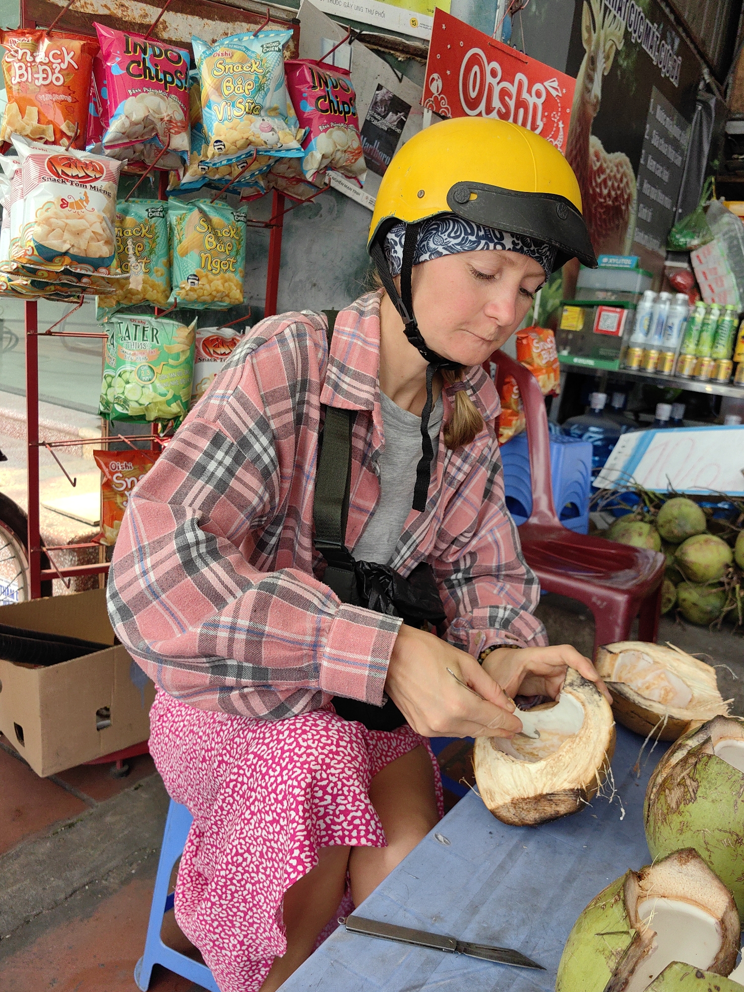 Tourists enjoy fresh coconuts at Vietnam street café