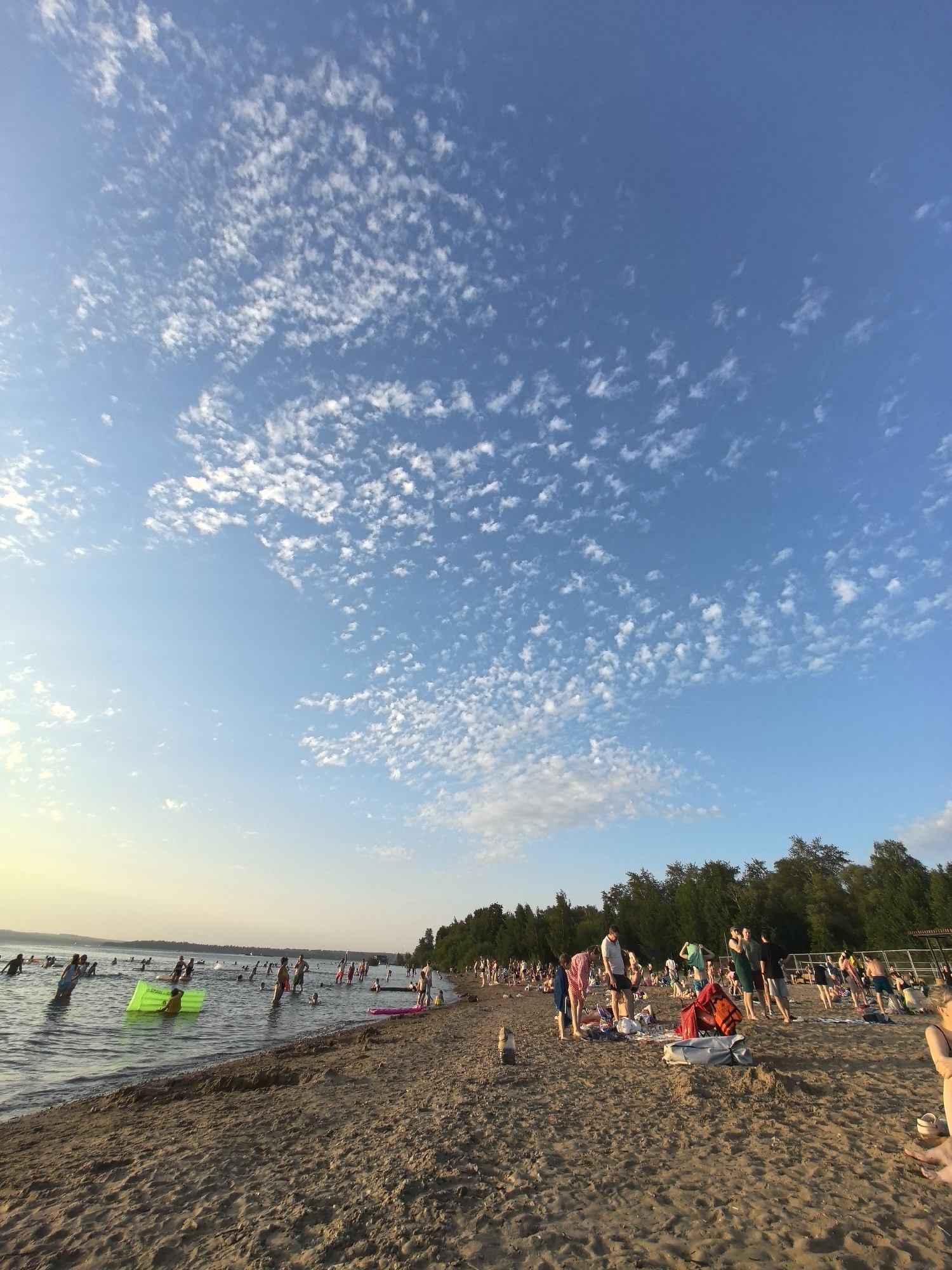 Summer afternoon on the Perm riverbank, sun and swimmers
