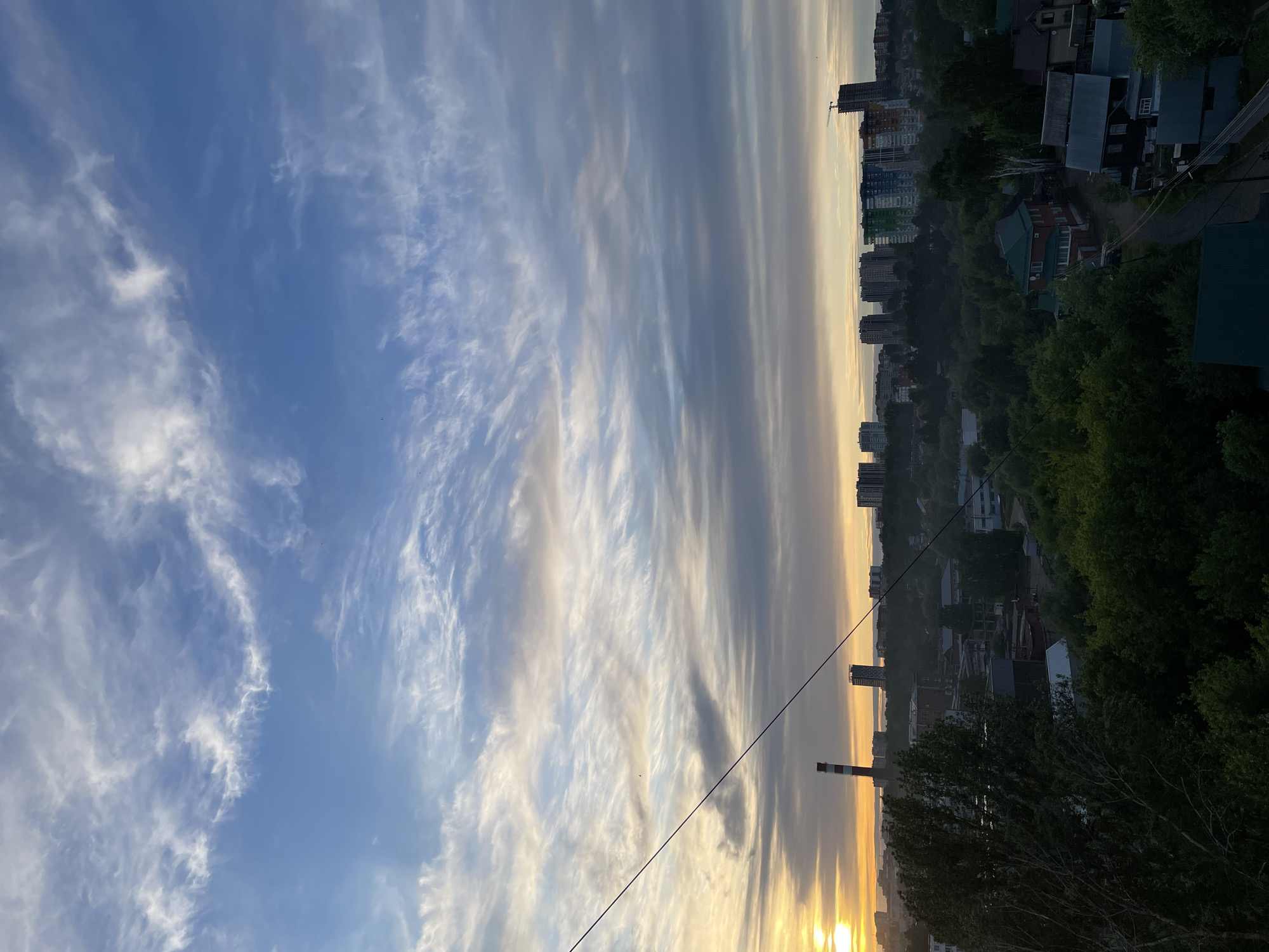 Sunset captured over Izhevsk cityscape with dramatic cloud formations