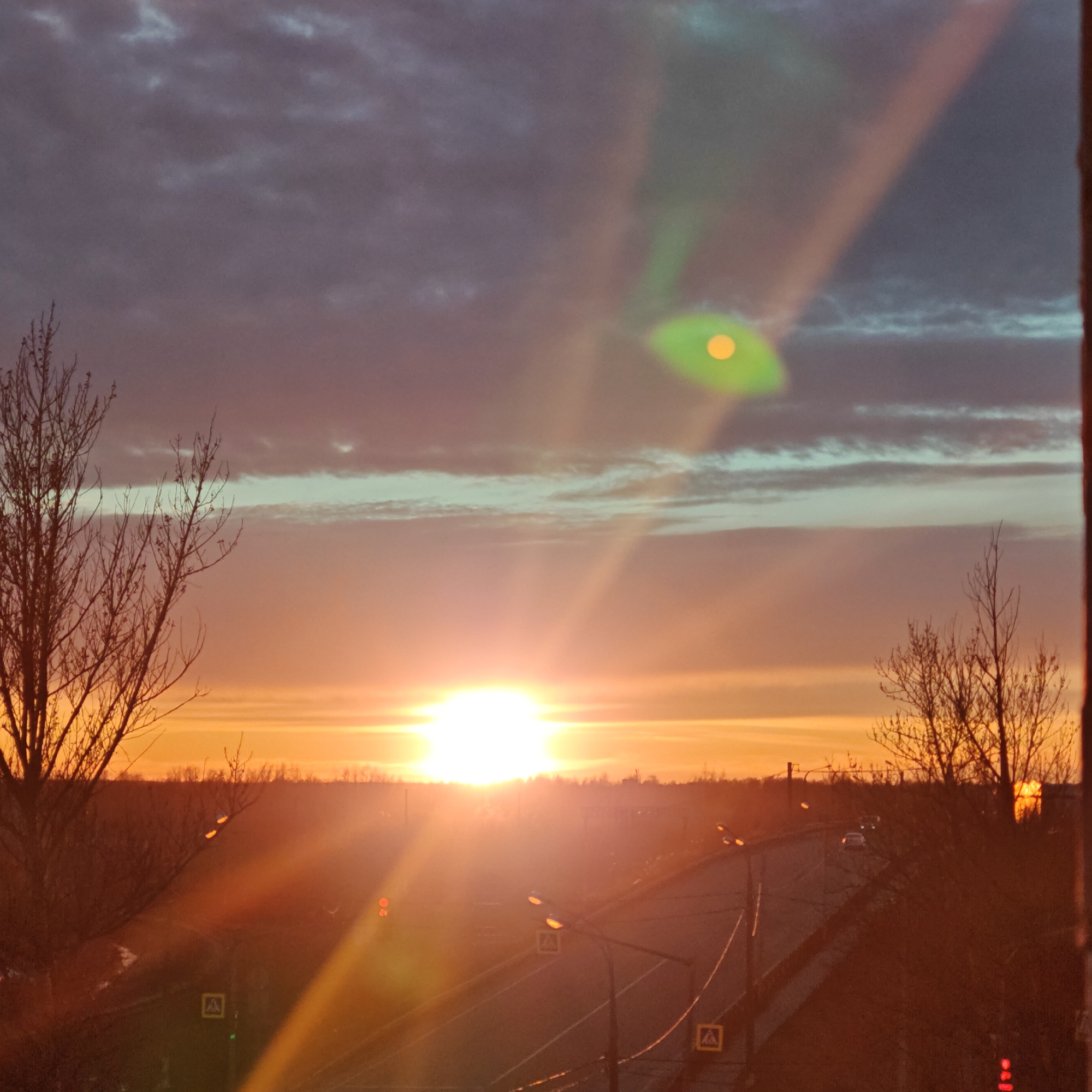 Sunset documented over Rostov cityscape with orange glow