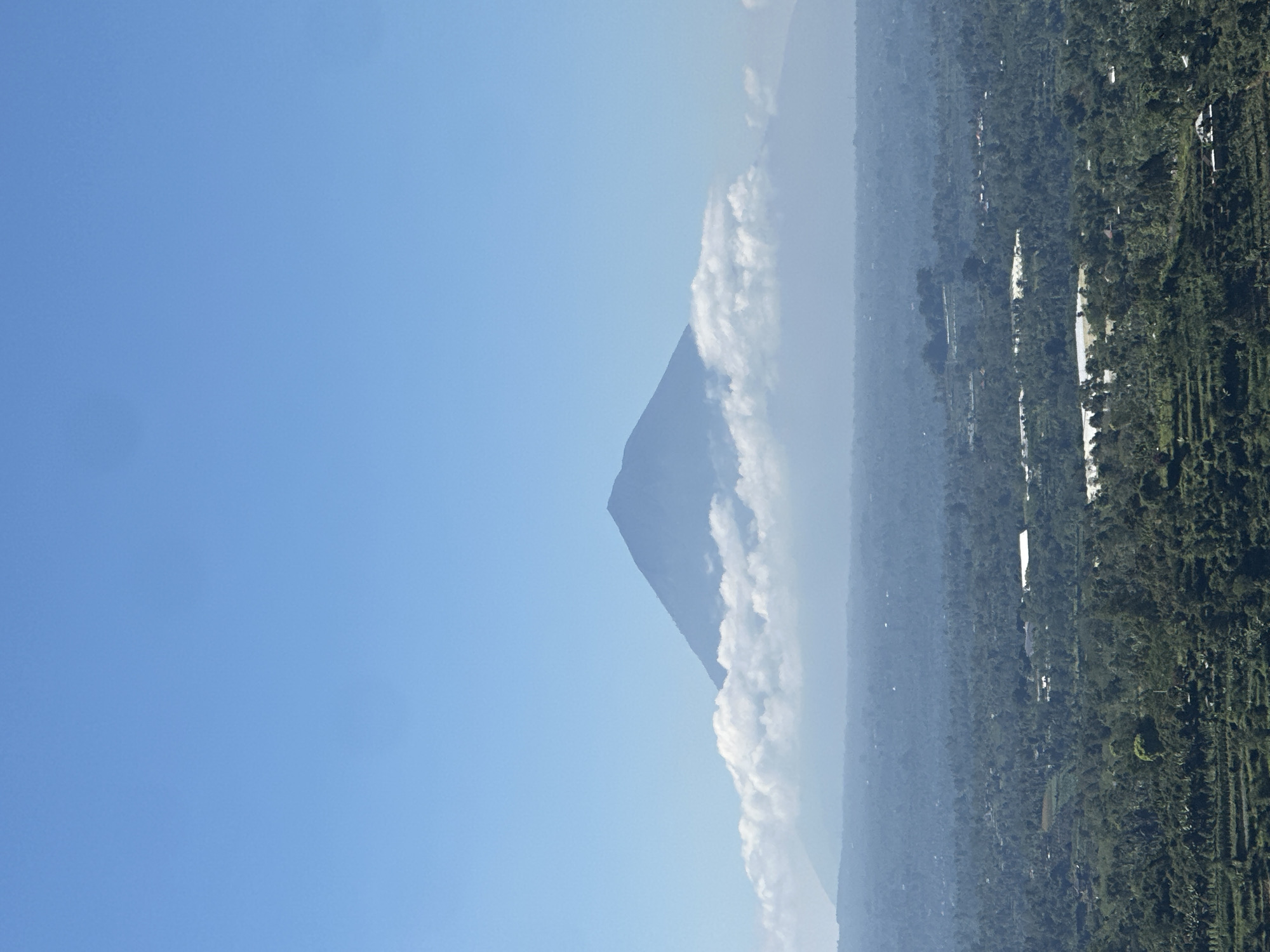 Mount Batur rises over terraced fields in Baturiti, Bali