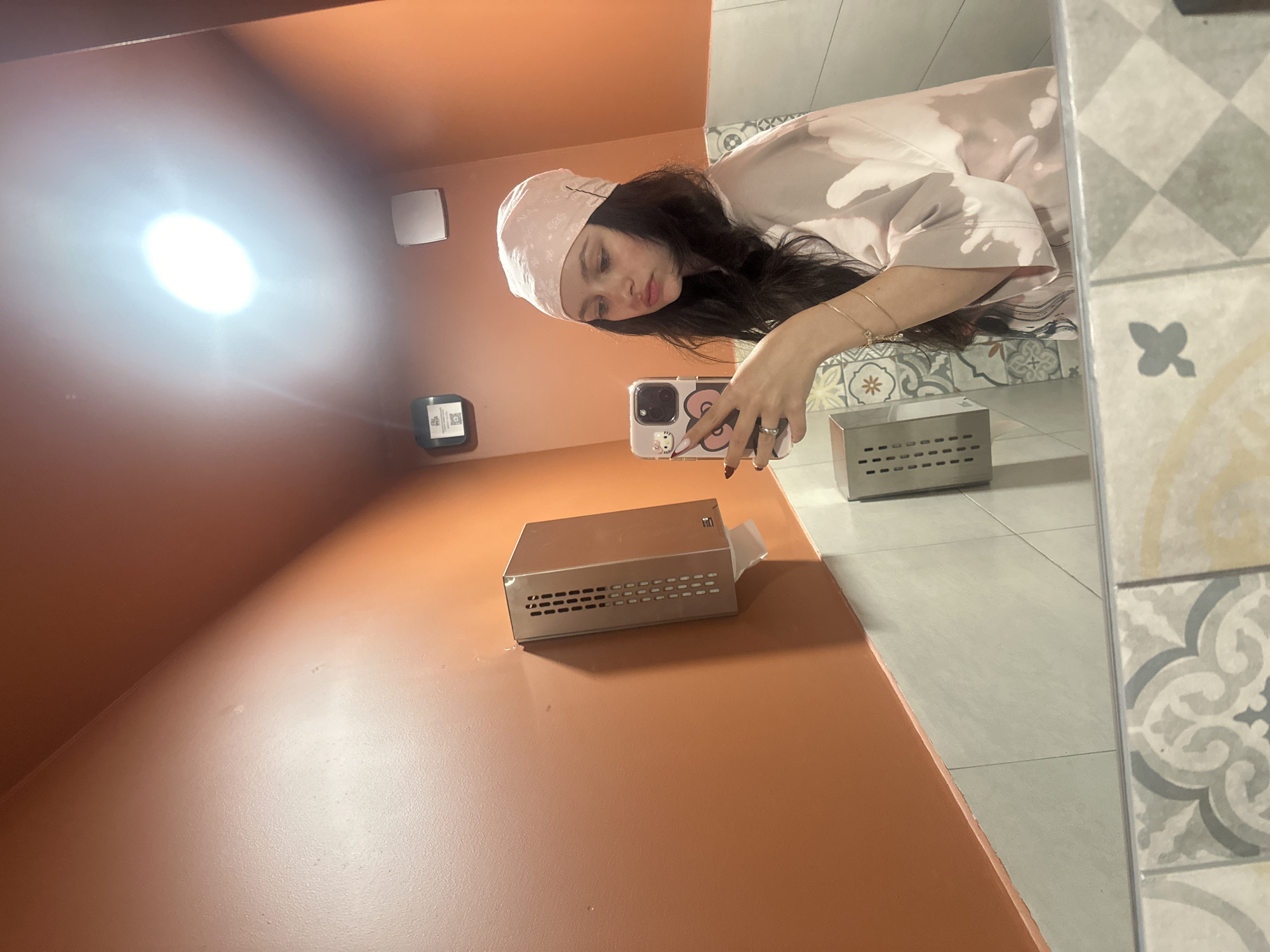 Woman takes bathroom mirror selfie in Yerevan