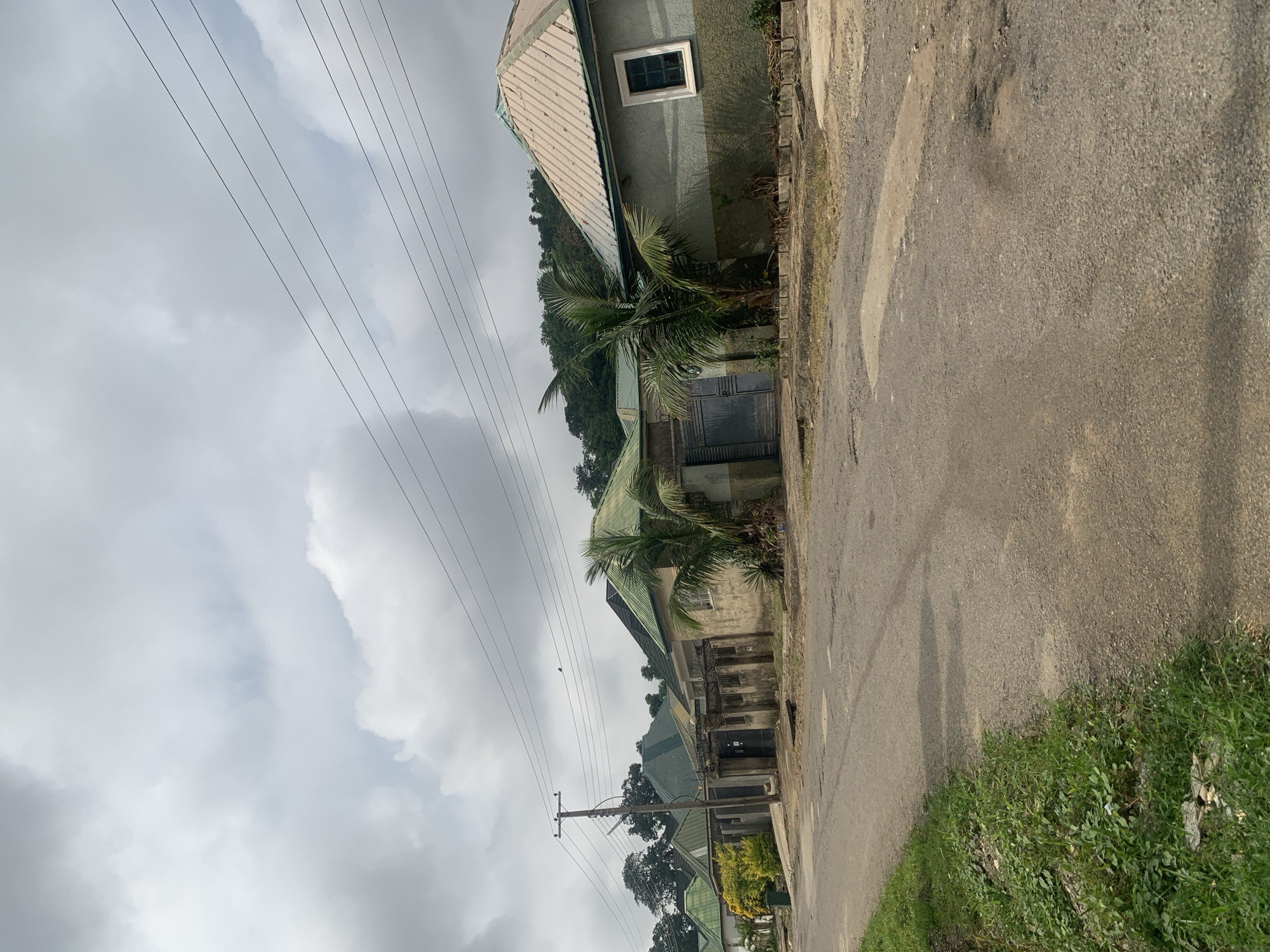 Morning foot traffic through a residential Abuja neighborhood