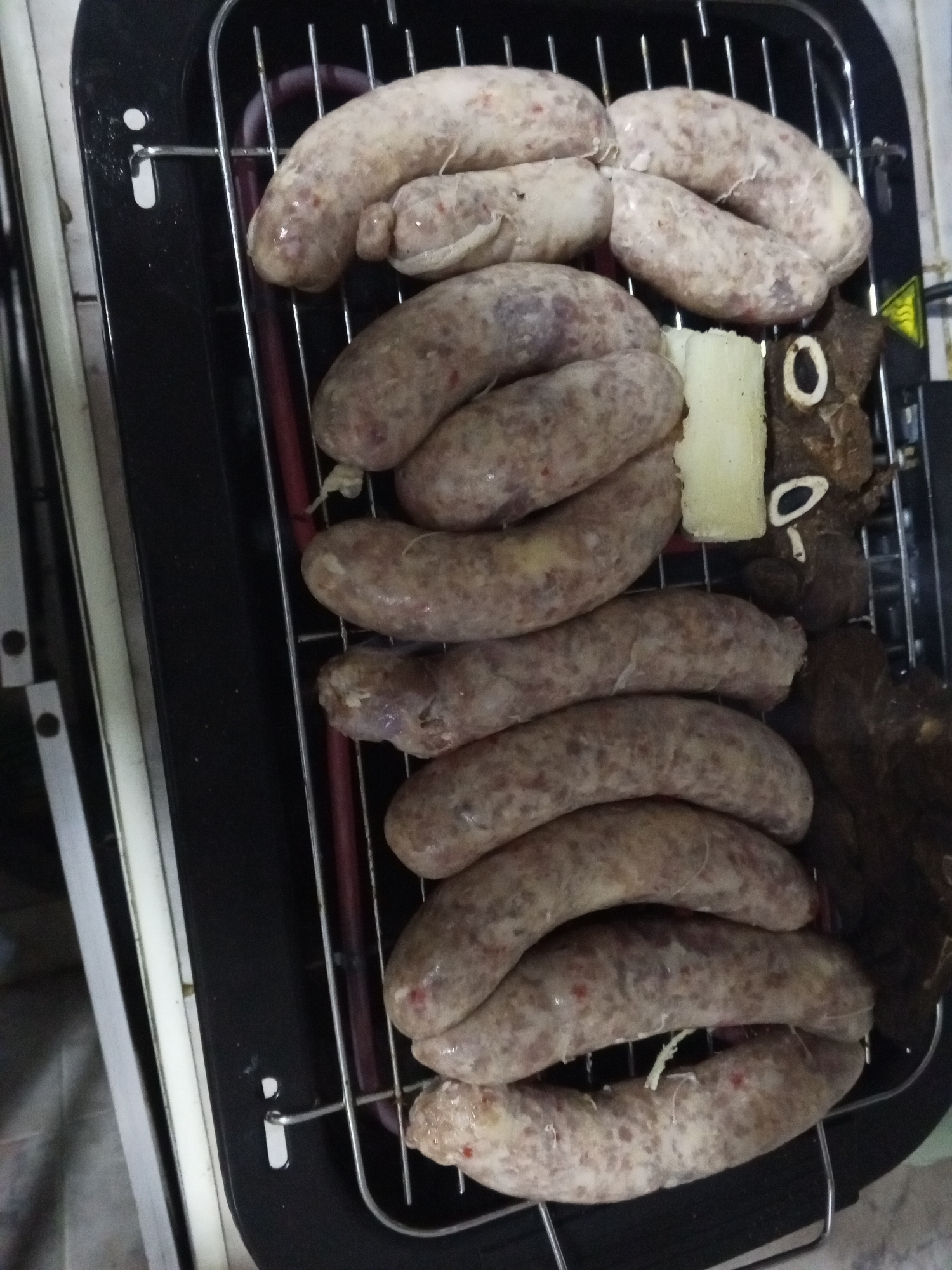 Evening sausage cooking session documented in Tinaquillo, Venezuela
