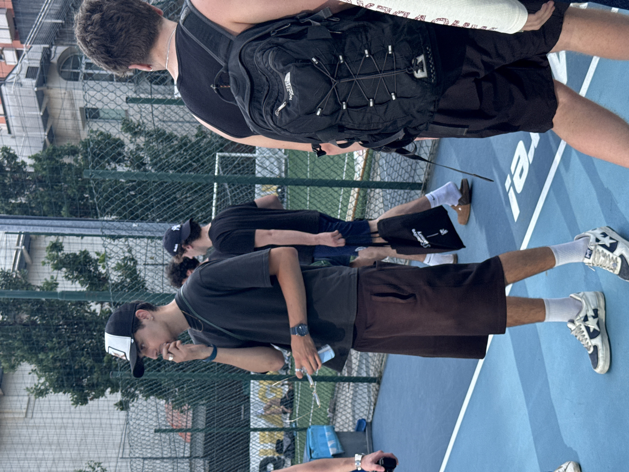 Young men play pickup basketball in Milan afternoon