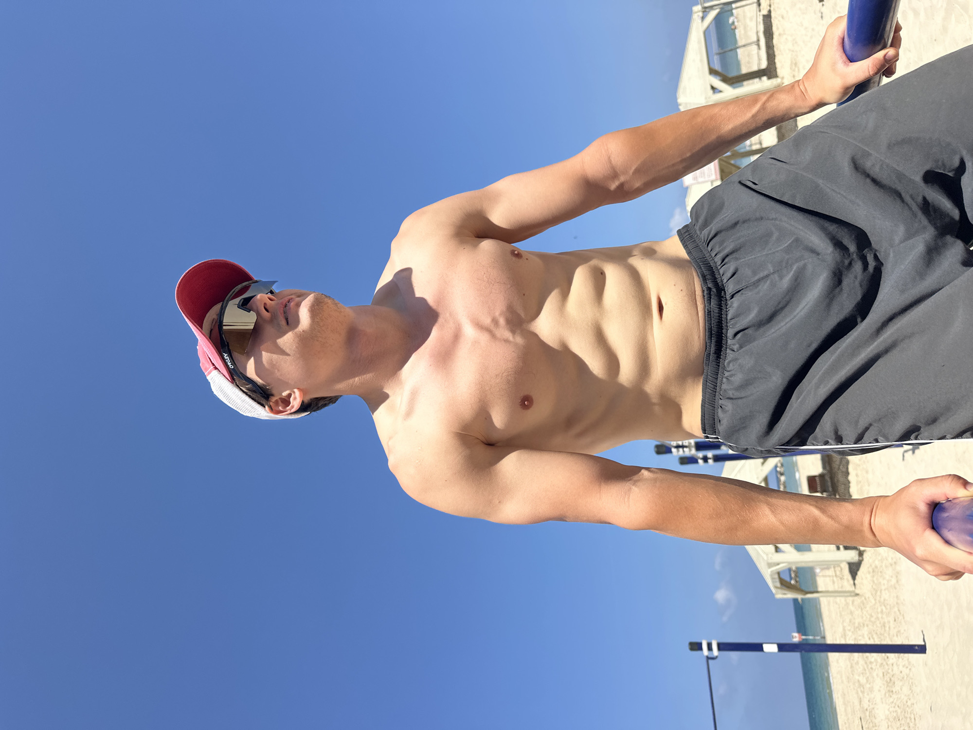 Man exercises on beach workout equipment in Tel Aviv