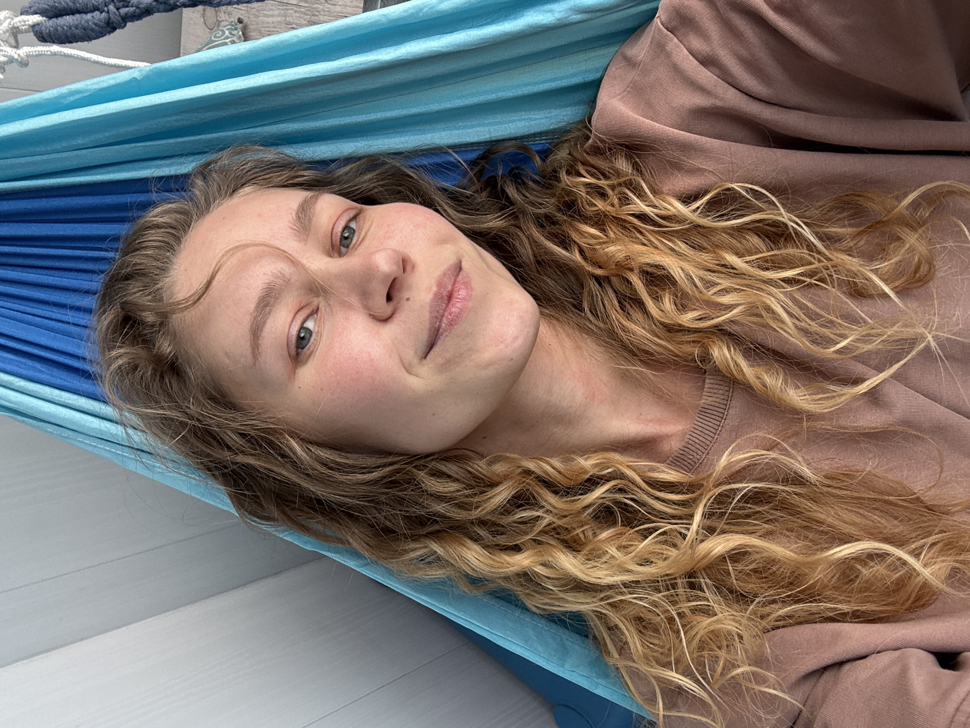 Woman rests in hammock during quiet morning in Kladovitsy