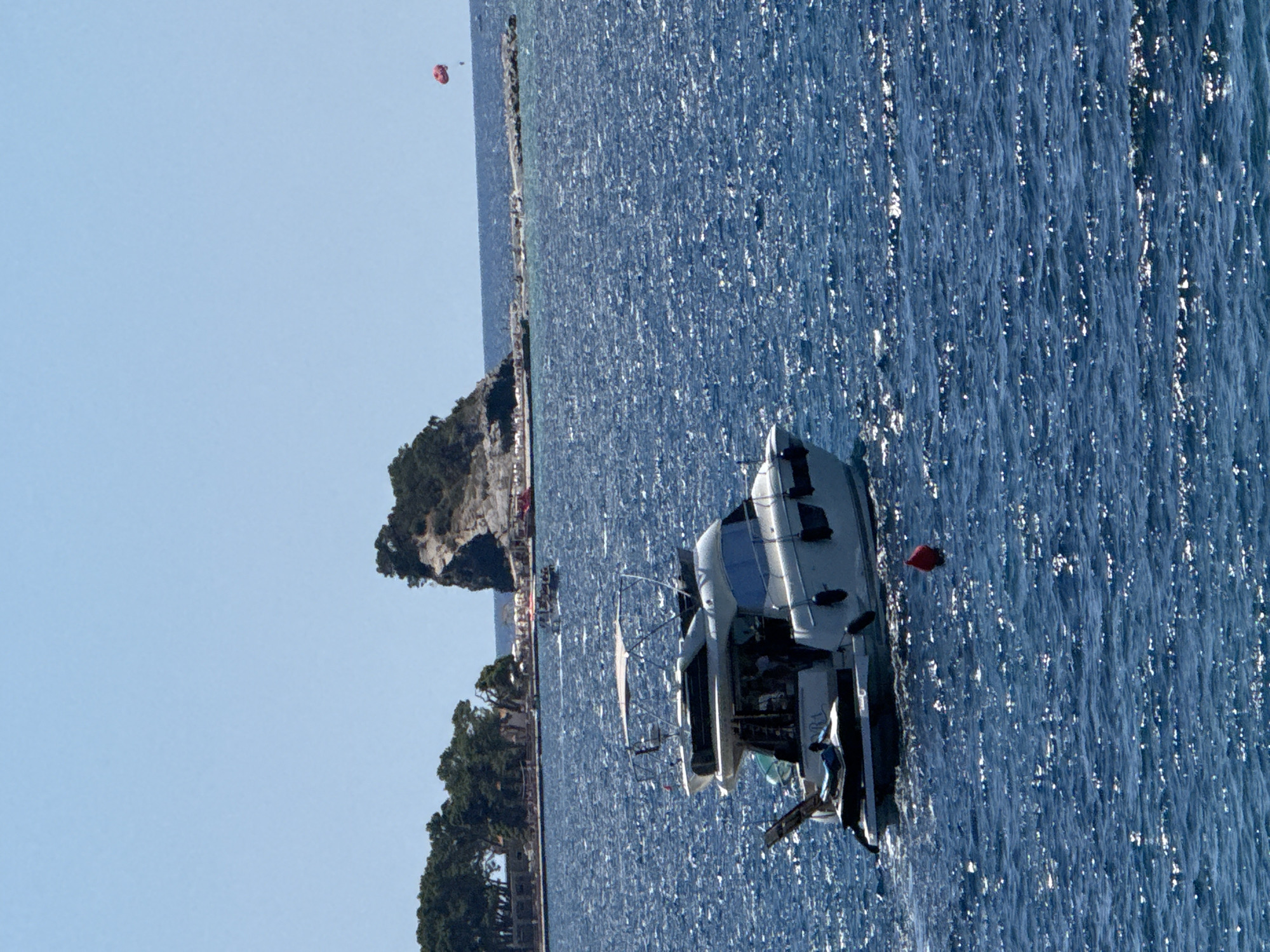 Yacht and paddleboarders on the Budva coast