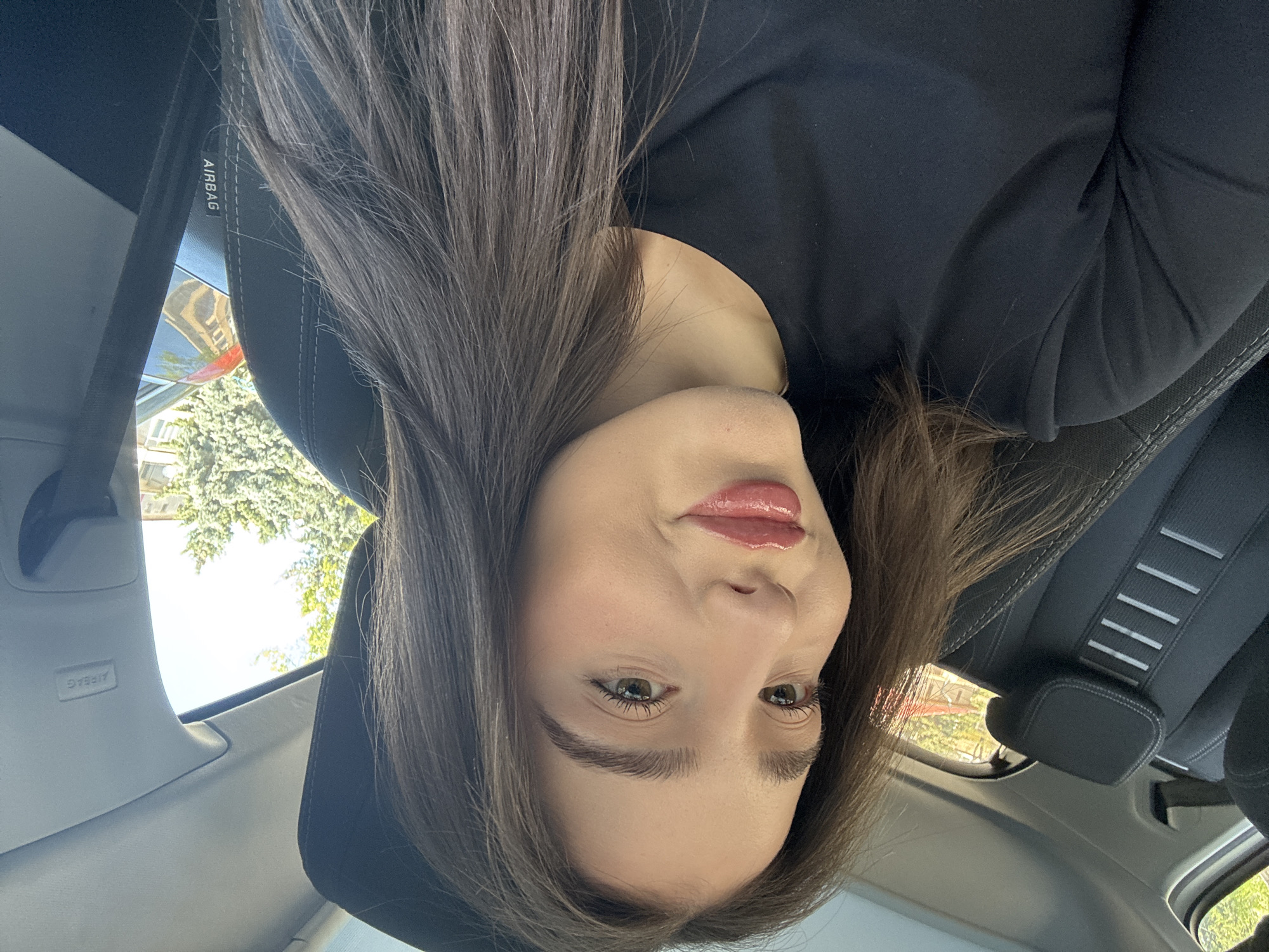 Woman takes selfies in car during morning photo session