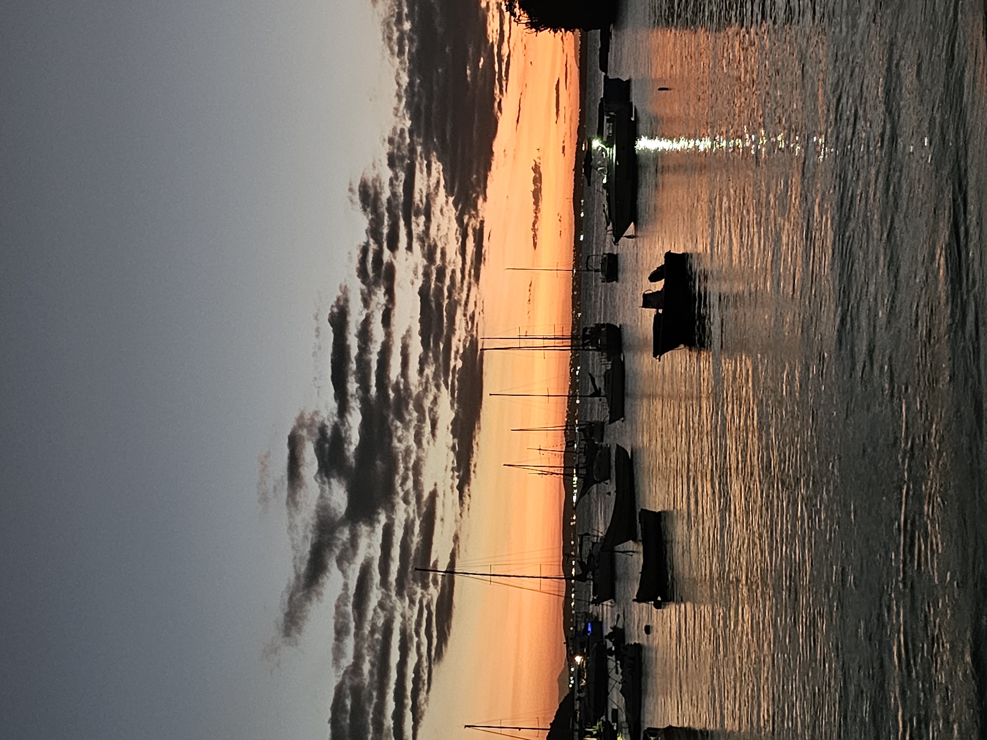 Sunset illuminates sailboats in Armação Dos Búzios harbor