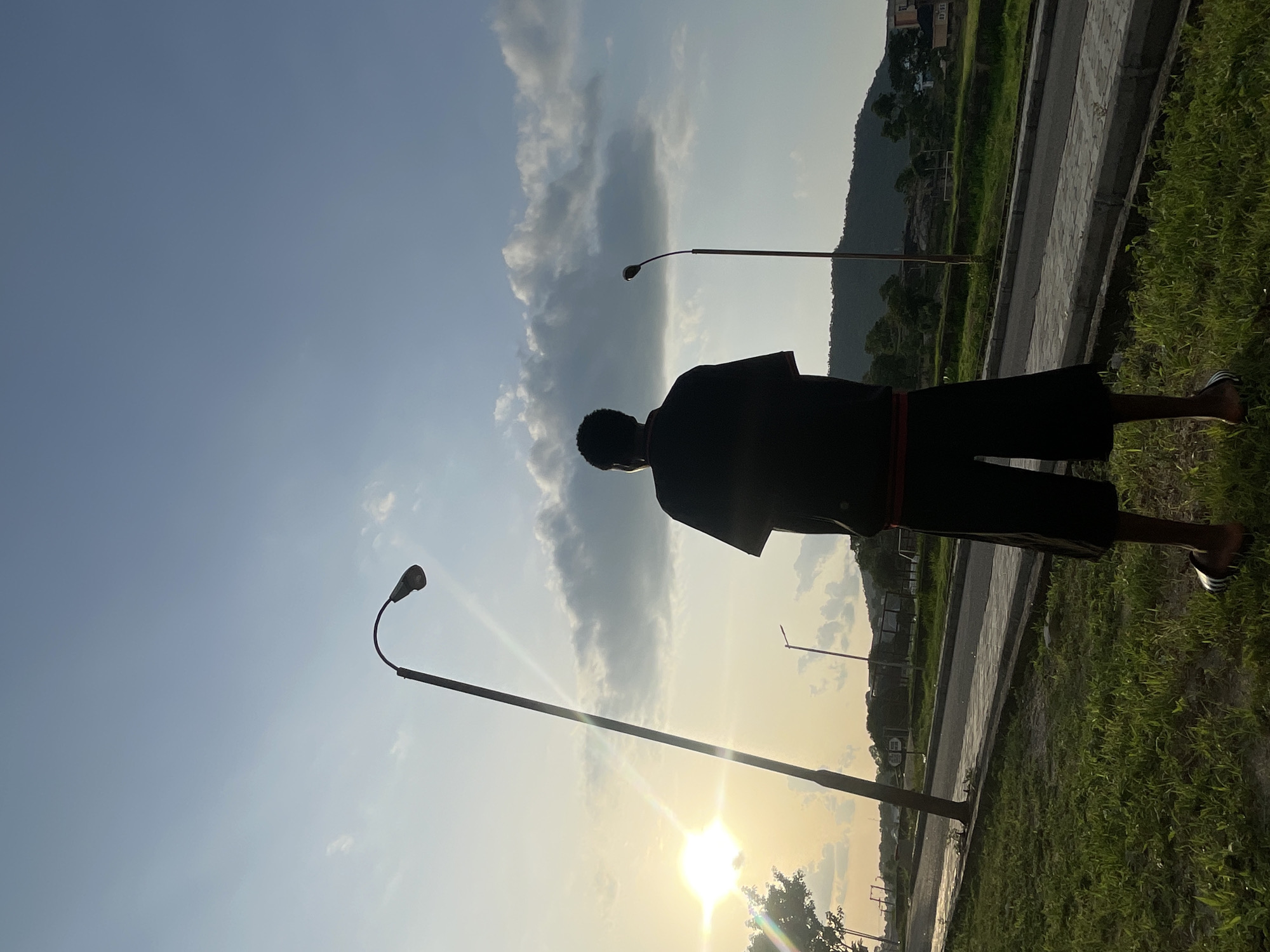 Young man's evening routine captured across Lokoja during sunset