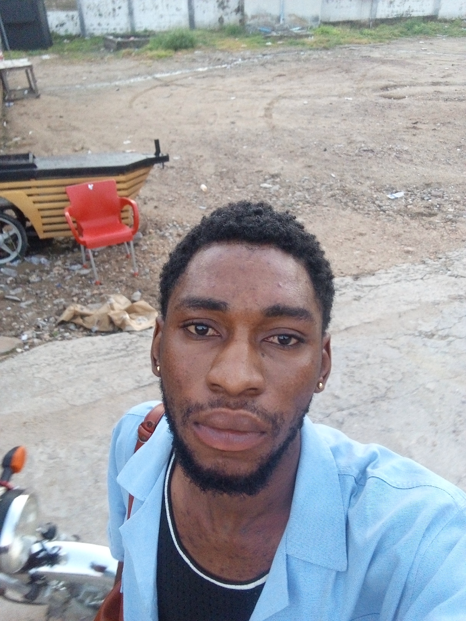 Early morning selfie session outside a lit venue in Lokoja