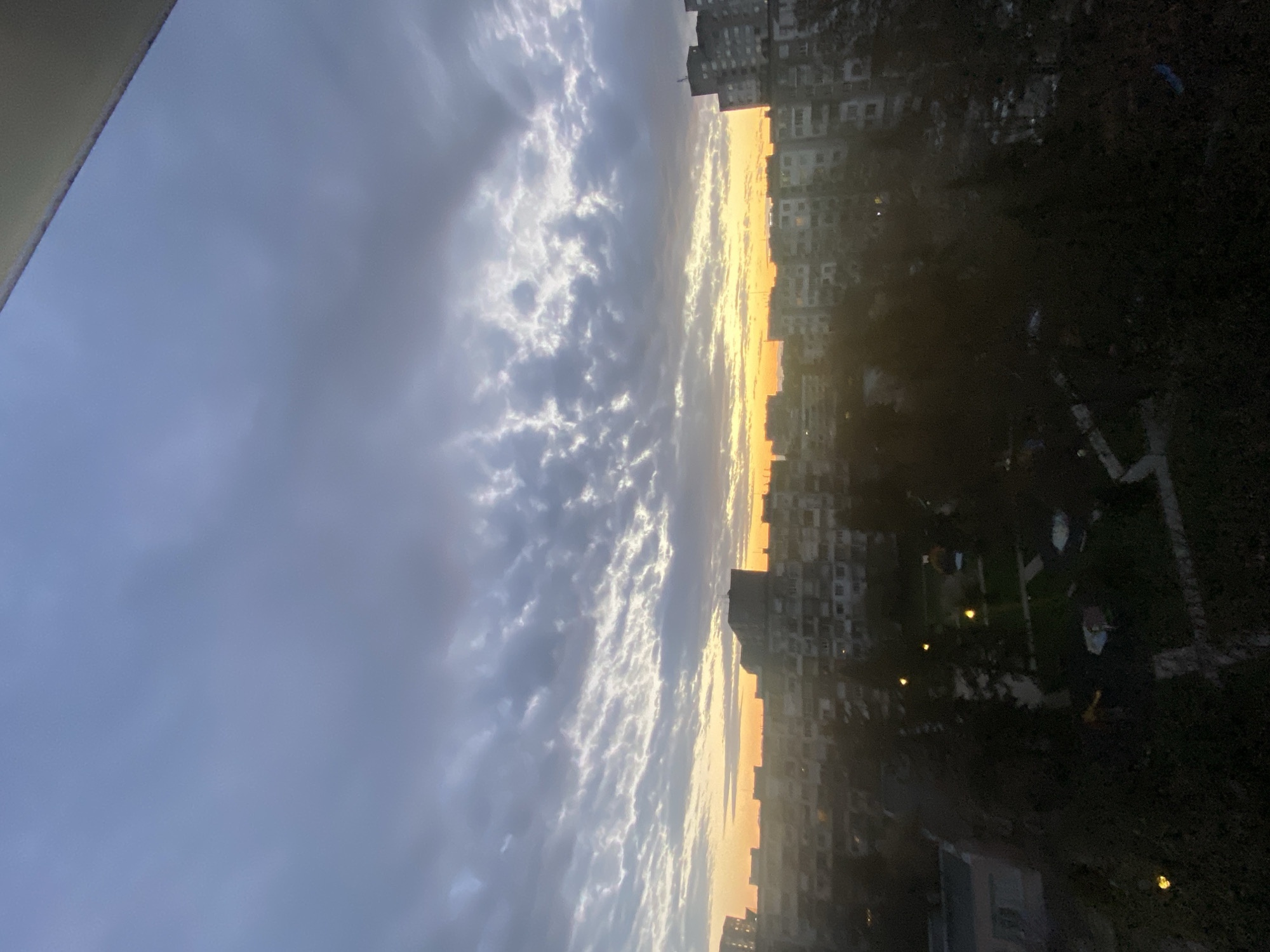 Golden twilight illuminates Sofia skyline through breaking clouds