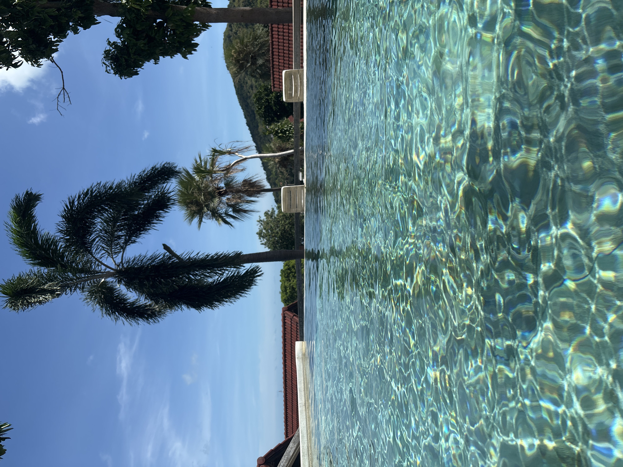 Mother and child enjoy early morning pool time in Thailand