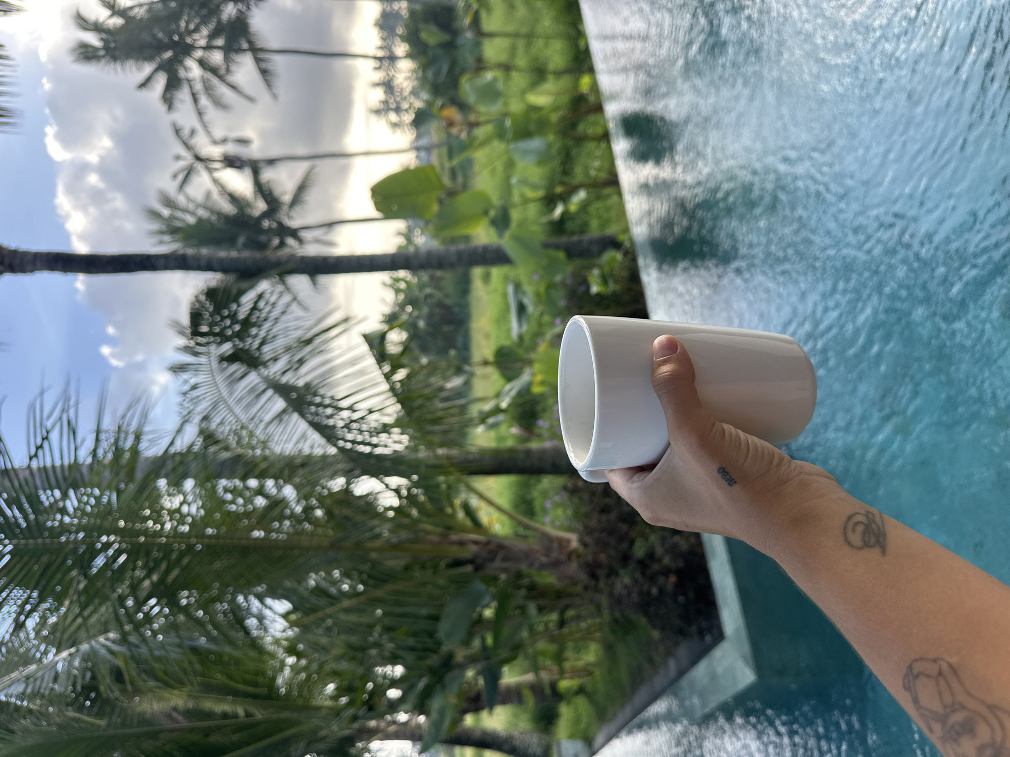 Morning coffee by tropical pool in Sukawati, Indonesia
