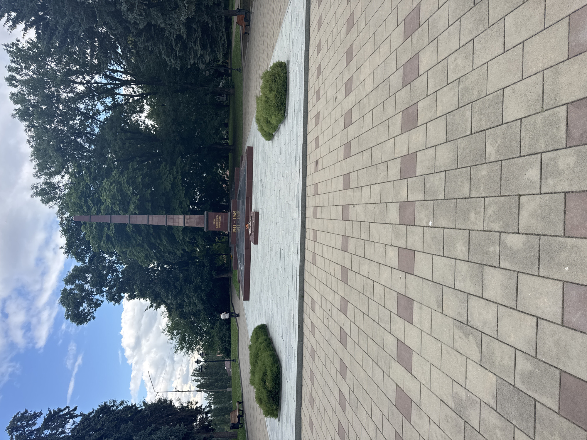 Exploring a formal memorial park with obelisk and monuments