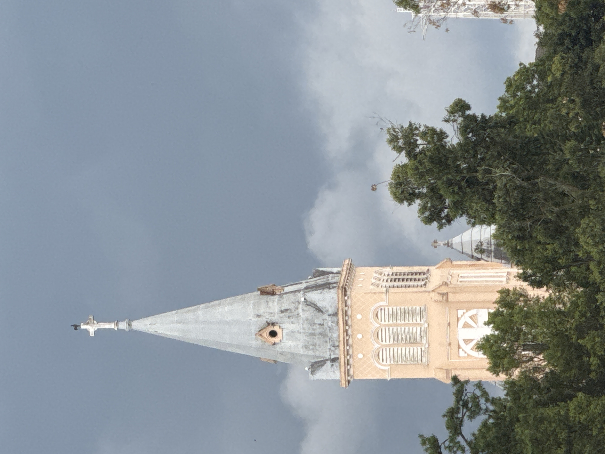 Da Lat street-level mix: cathedral, market stalls, and city towers