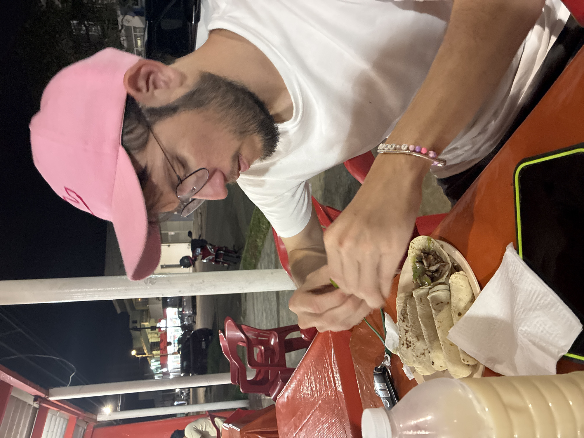 Man enjoys tacos at casual restaurant in Coatzacoalcos
