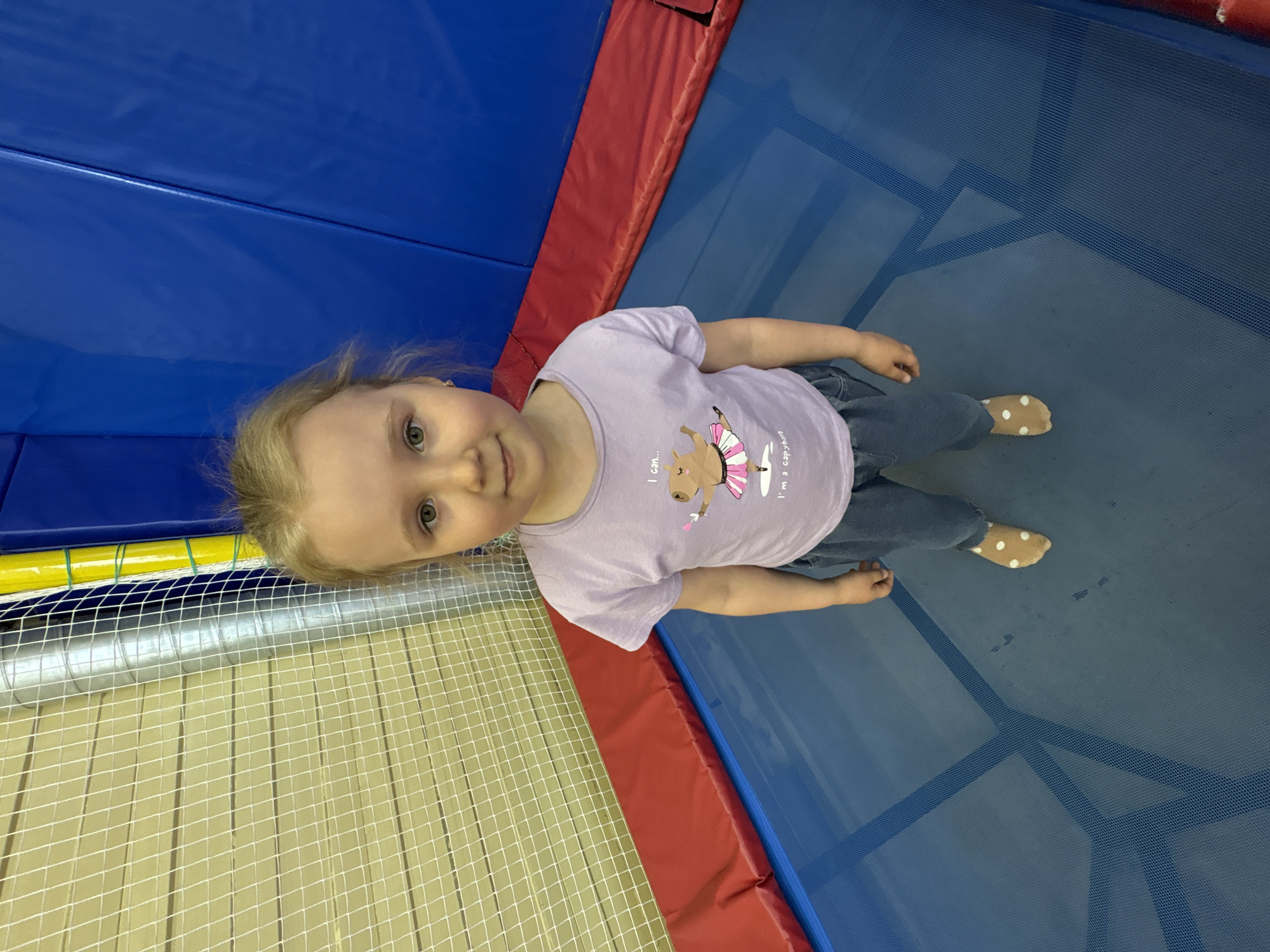 Young girl enjoys trampoline play at indoor recreation facility