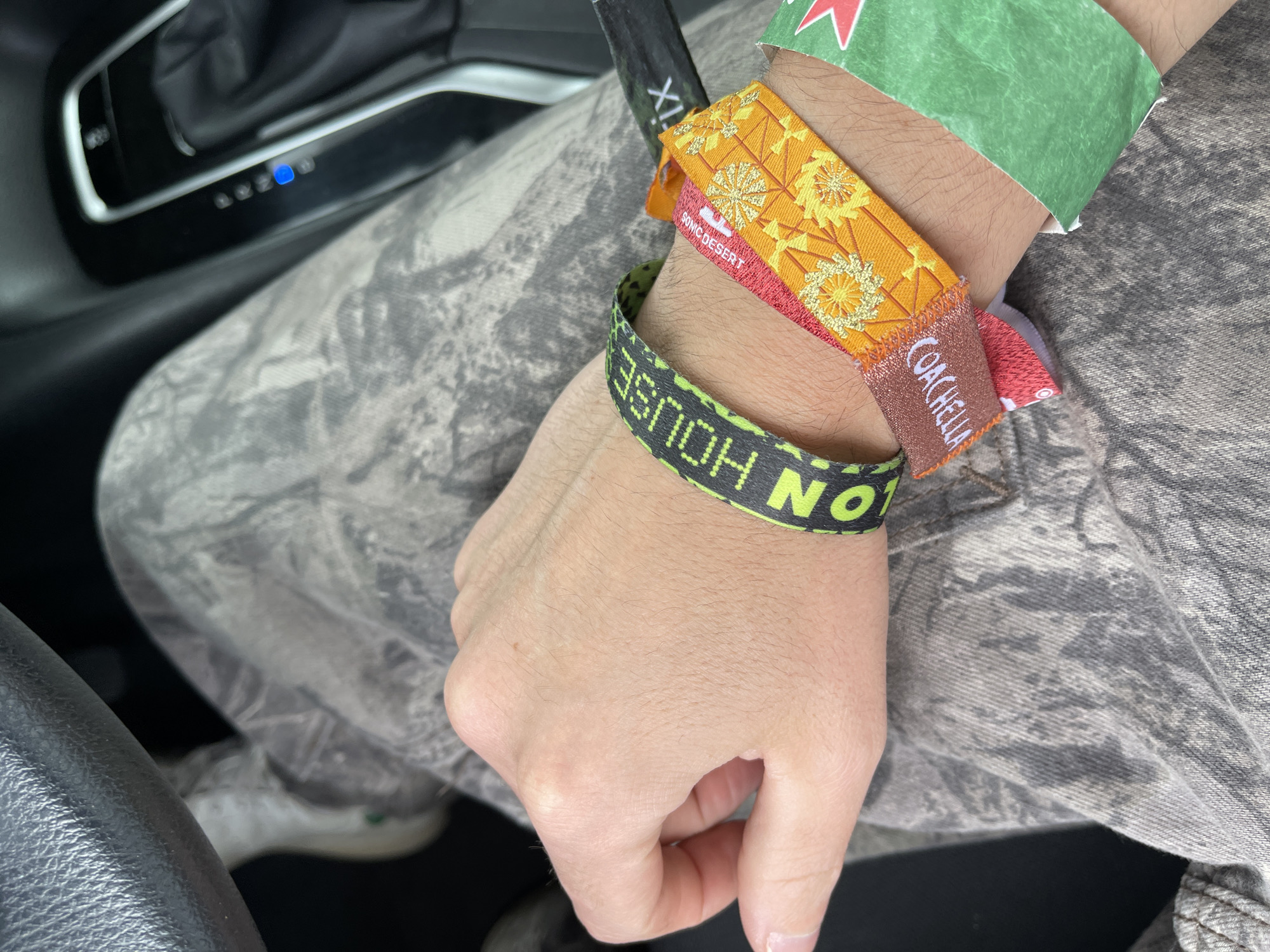 Festival-goer shows off Coachella, Sonic Desert wristbands in Palm Springs