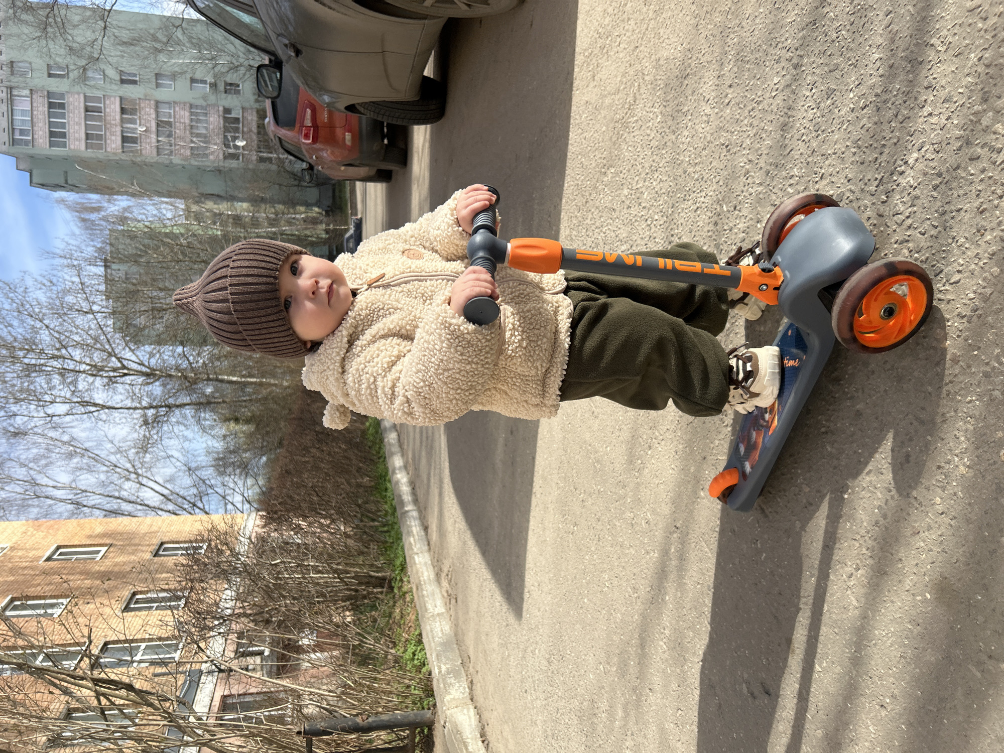 Mother and child enjoy morning scooter ride in Russian park