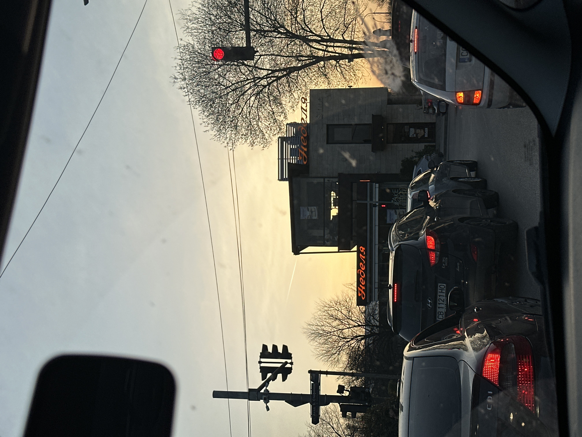 Evening traffic flows through central Sofia near Nedelya shop