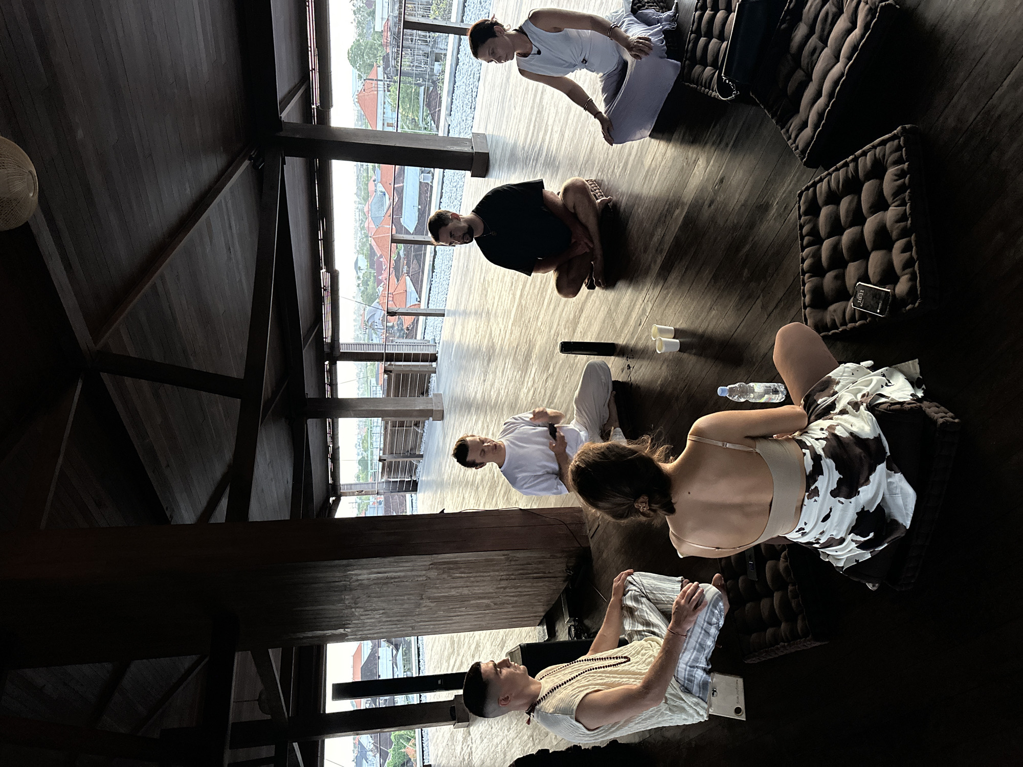 Group holds meditation session in wooden pavilion in Mengwi