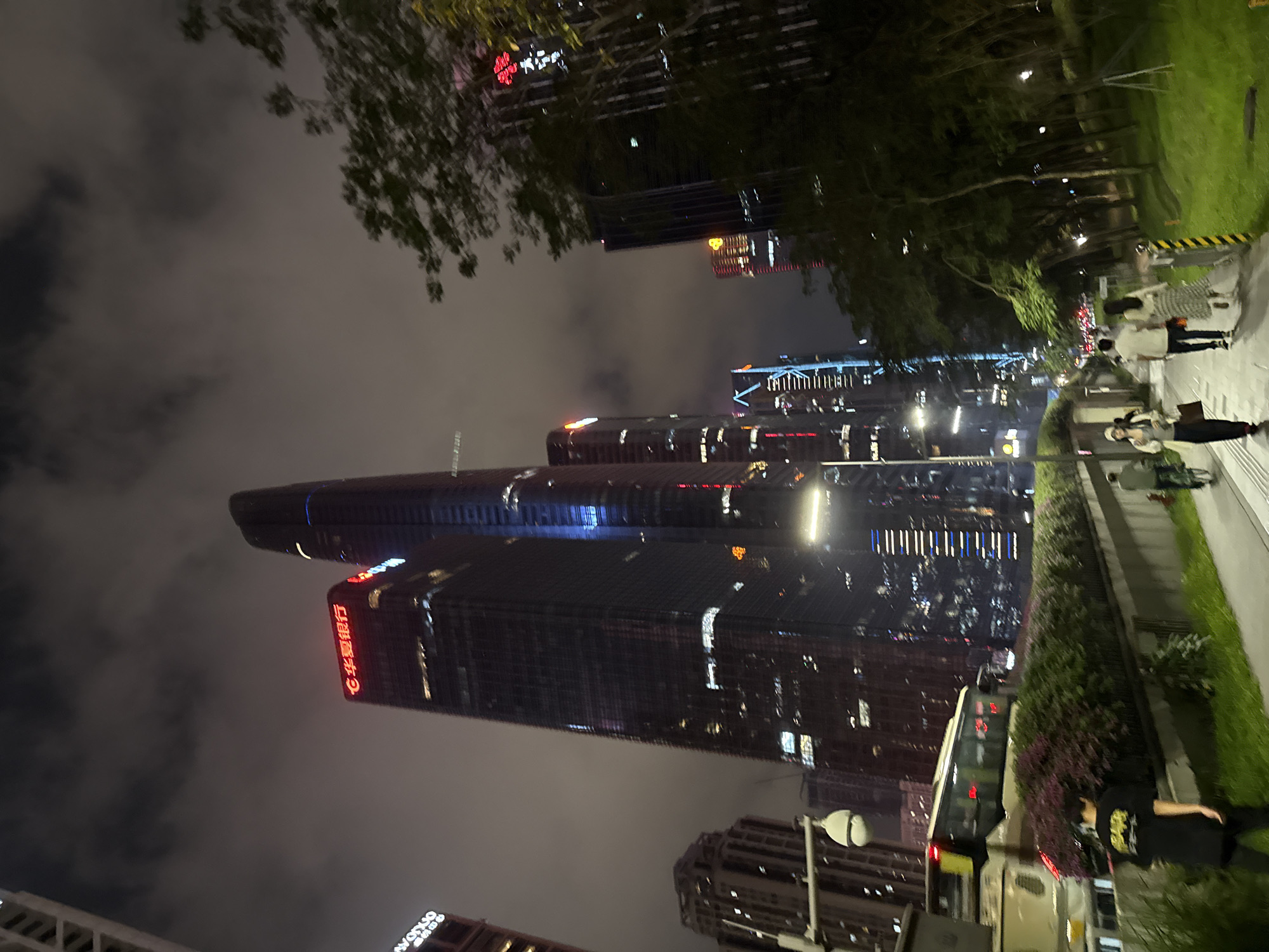 Crowds gather in Shenzhen plaza during illuminated skyscraper light show