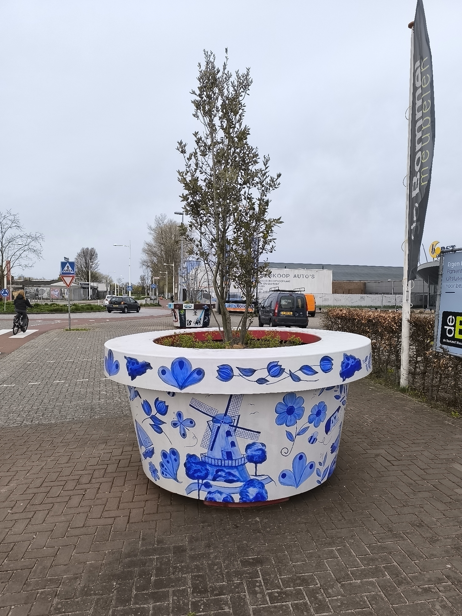 Decorative planters spotted on Alkmaar street display contrasting artistic styles