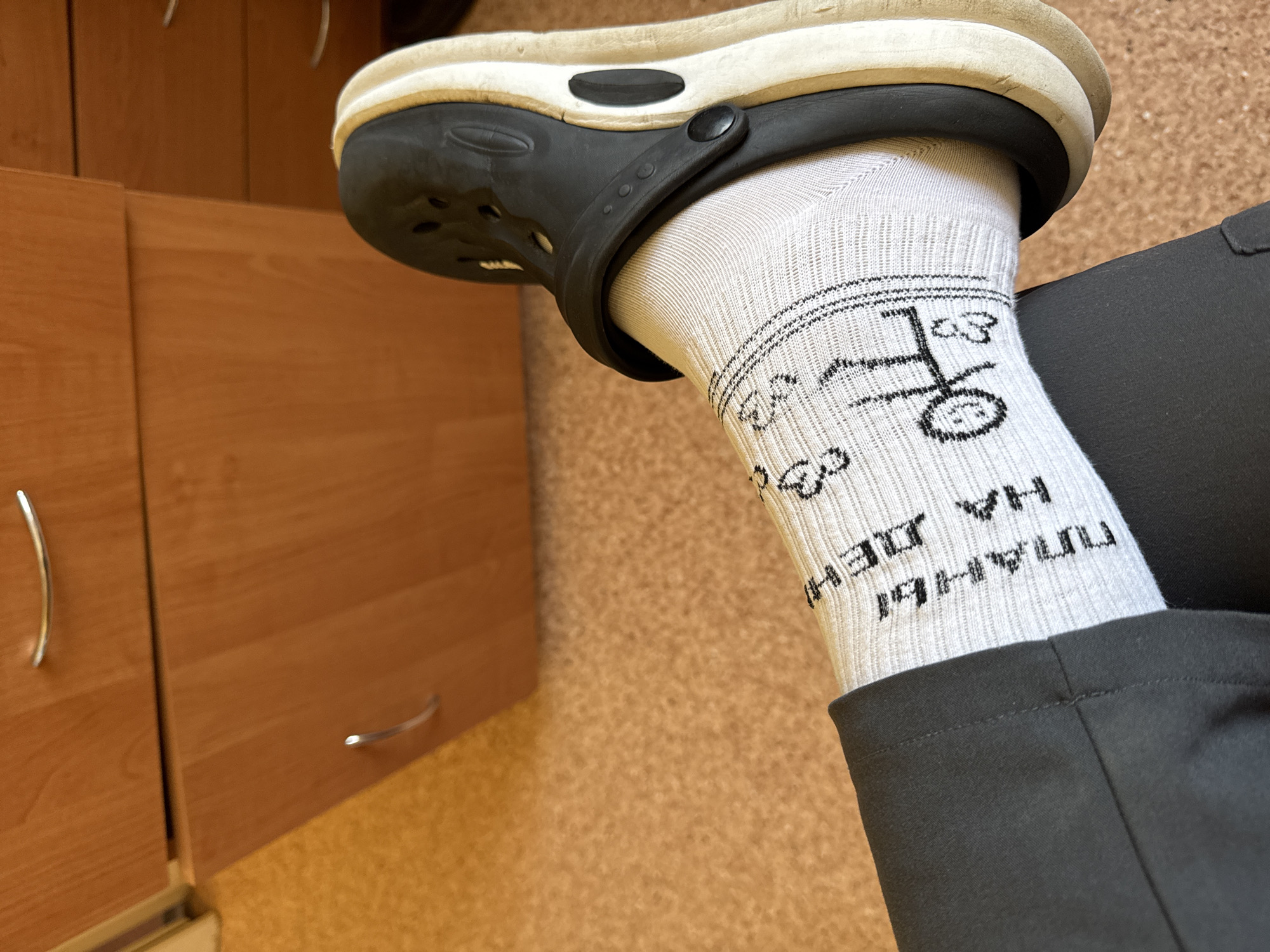 Bicycle-themed sock and Croc shoe documented in rural Belarus